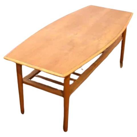 Introducing our stunning Mid Century Teak Danish Style Surf Board Coffee Table, the perfect addition to any mid century inspired living space. Crafted from beautiful teak wood, this coffee table showcases the natural grain and warmth of the wood,