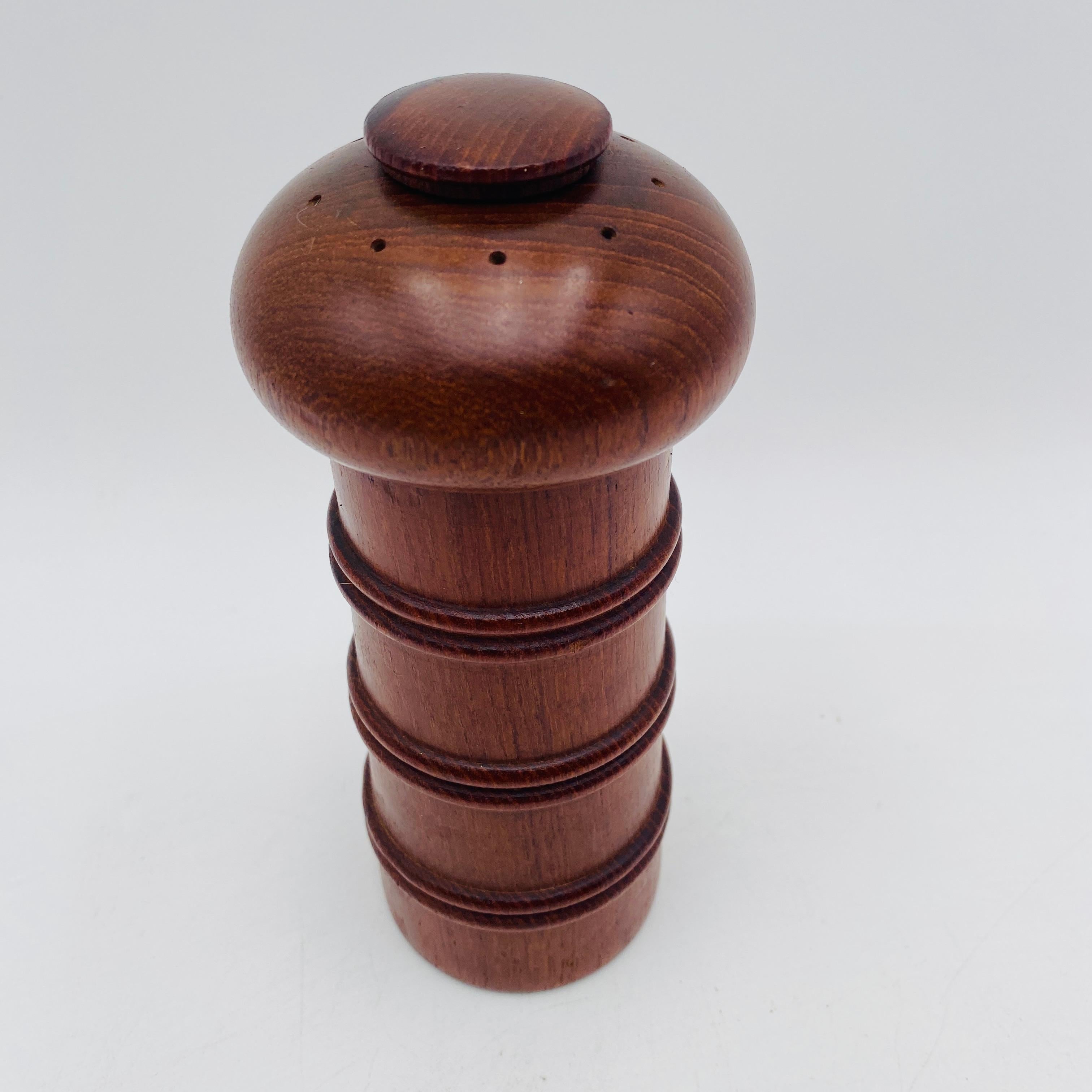 Eine ikonische, skulpturale Salz- und Pfeffermühle aus Teakholz aus der Mitte des Jahrhunderts, entworfen von Jens Harald Quistgaard für Dansk. Dieses Stück hat einen pilzförmigen Aufsatz mit einem abnehmbaren Stöpsel zum Einfüllen von Salz und ein