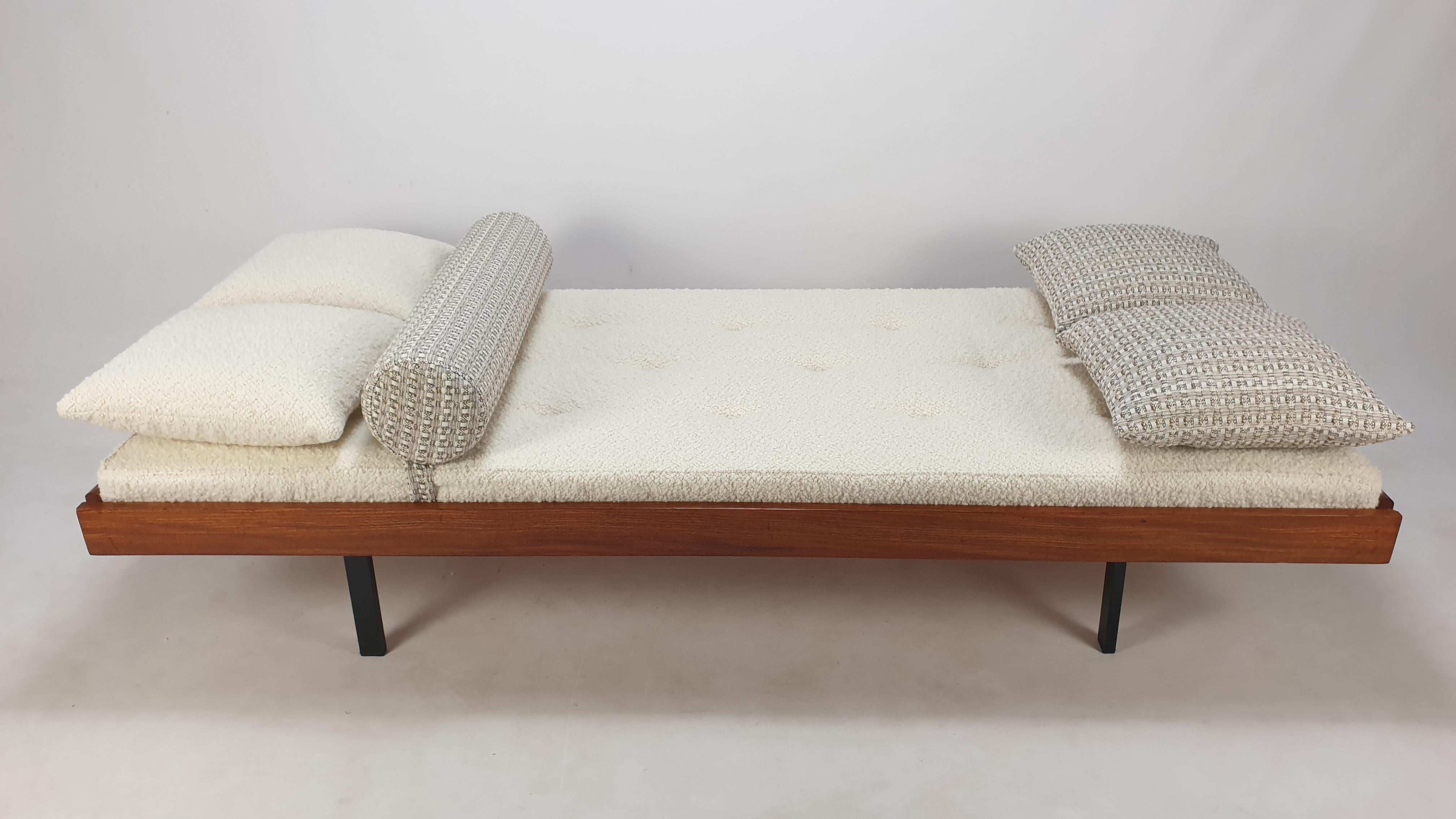 Very nice teak daybed, fabricated in The Netherlands in the 60's. 
It has 4 folding feet, see the last pictures.

The mattress is renewed with new foam and it has just been upholstered with lovely Italian bouclé wool fabric, the same for two