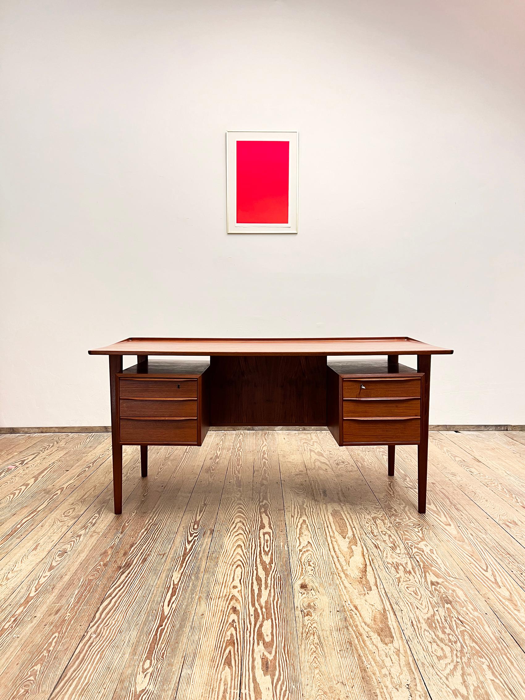 Dimensions 74 cm x 155 cm x 70 cm (Depth x Width x Height)


This free standing midcentury danish writing desk was designed by Peter Løvig Nielsen, produced by Hedensted Møbelfabrik Denmark in 1968. The table is made of teak wood and features two
