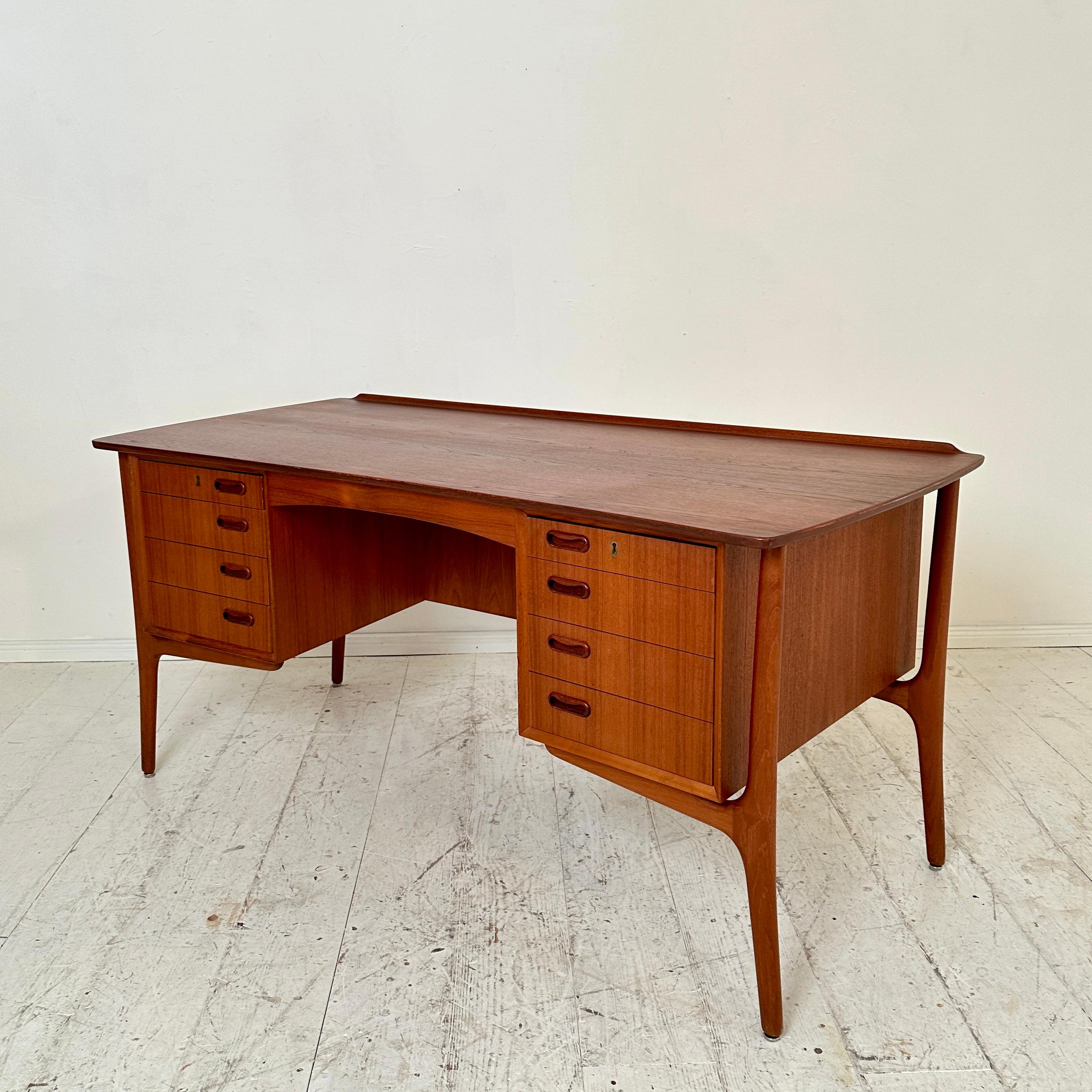 Crafted circa 1960, the Mid Century Teak Desk by Svend Aage Madsen for H.P. Hansen stands as an epitome of Danish modern design. Madsen's meticulous craftsmanship and H.P. Hansen's legacy converge in this iconic piece, showcasing the era's emphasis