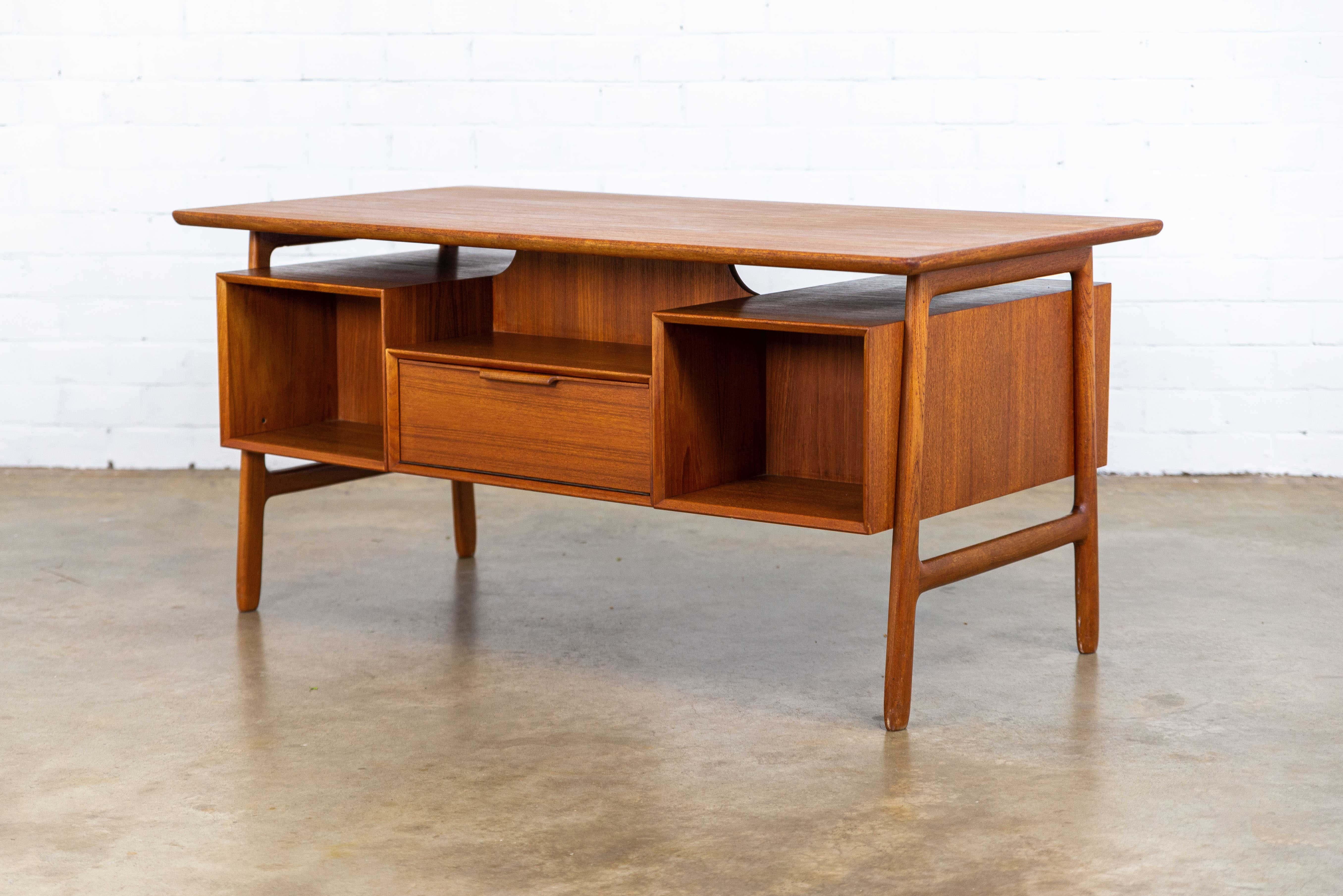 This beautiful teak desk is designed for Omann Jun Møbelfabrik in Denmark, model 75.
The freestanding desk has a floating desktop, six drawers and one key.
James Bond desk.

   
