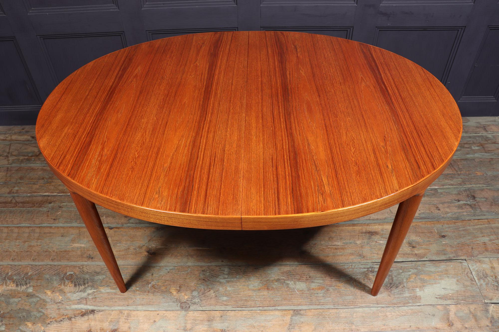 DINING TABLE BY JOHANNES ANDERSEN 
This teak extending dining table manufactured by Skovmand & Andersen in Denmark is a functional and well-crafted vintage piece. With a sturdy teak edging, tapering teak legs and a fantastic teak grain, the table