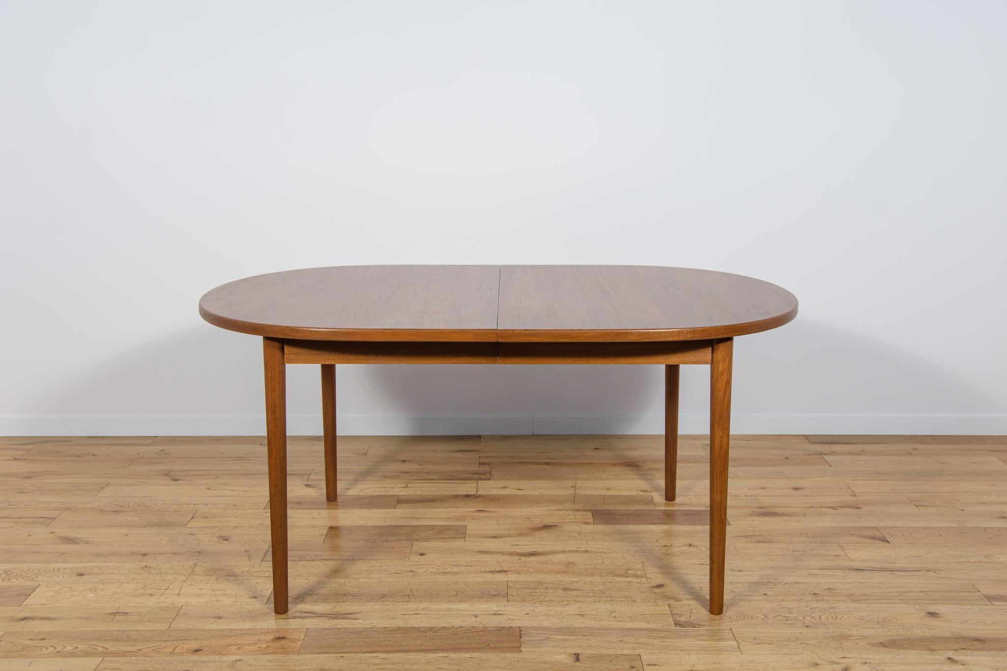 The large extendable teak table was designed in the 1960s by Nils Jonsson for the Swedish manufacturer Troeds. It has been completely renovated, cleaned of old surfaces, painted with oak stain, and finished with a strong semi-matt varnish. The table