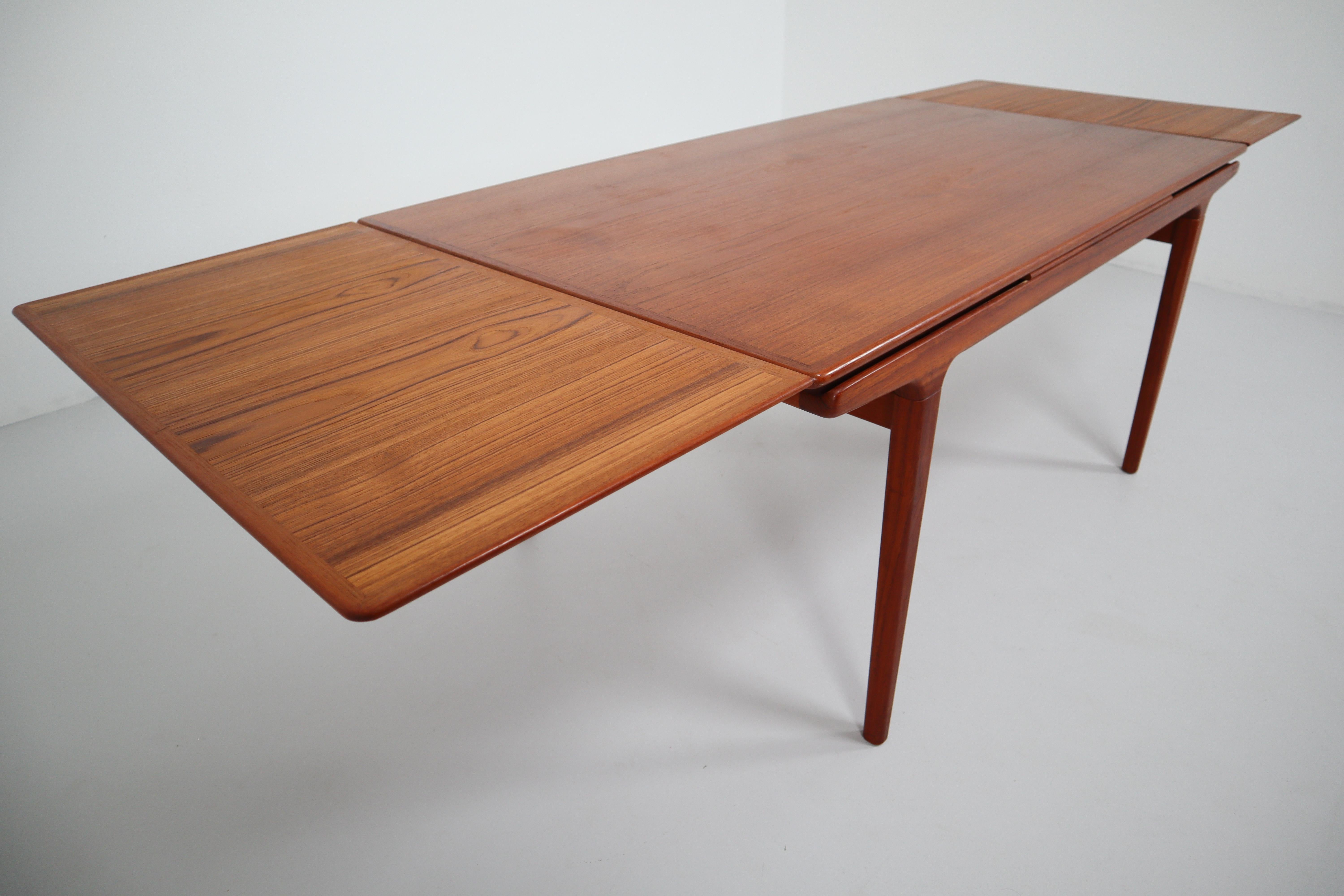 Designed by Niels Møller, this Danish modern extension table is notable for its beautifully tapered lines and the warmth of the teak. Two concealed leaves easily slide out allow ten persons to dine comfortably. Each extension is 50 cm.