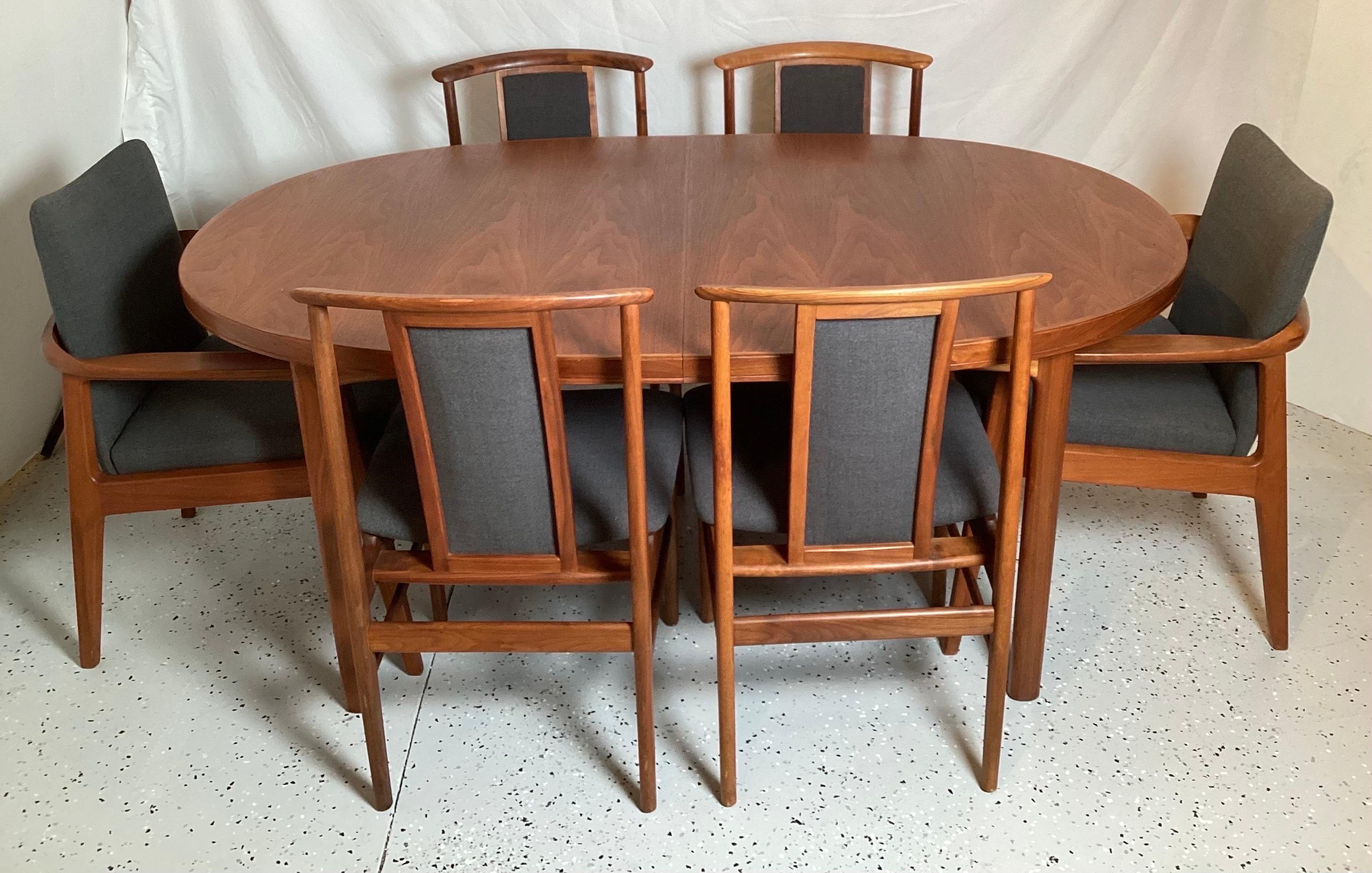 A teak wood dinning set with a table 65 by 41.75 with 2, 18 inch leaves, two arm chairs, 2 side chairs. Great medium size and well cared for condition.