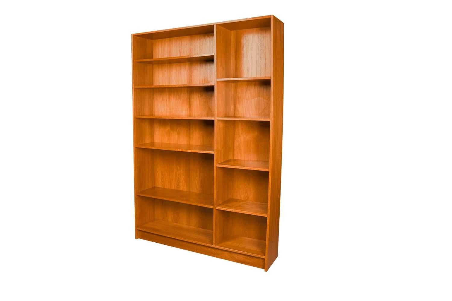 An exceptional teak tall Double bookcase made in Denmark by Domino Mobler. Gorgeous Mid-Century Modern Teak bookcase / tall bookshelf unit. Beautiful, minimalist, clean, straight lines. Features seven adjustable shelves providing ample storage