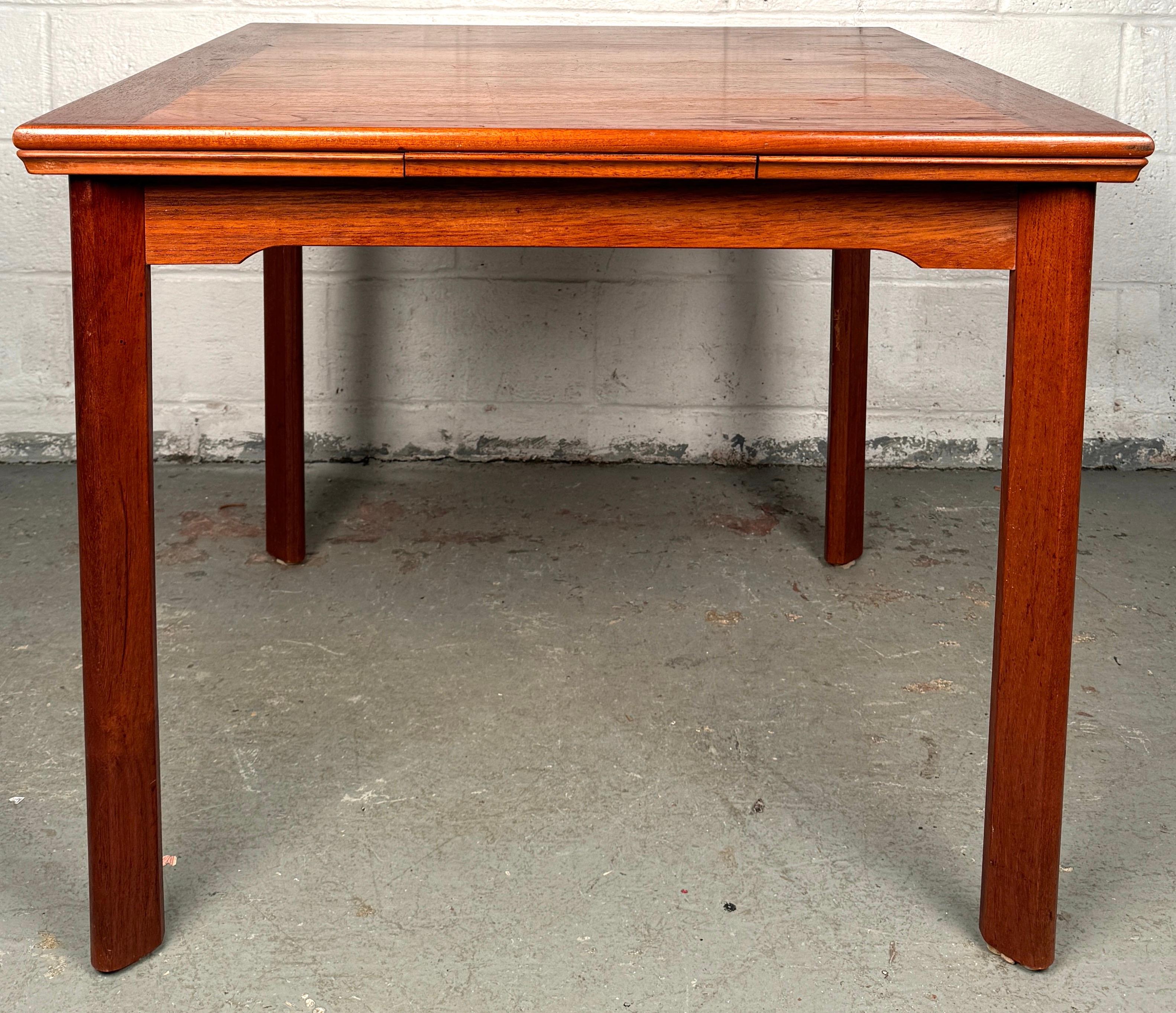 Celebrate the beauty of Danish design with this stunning mid-century teak draw-leaf dining table, crafted in Denmark during the golden era of Scandinavian modernism. With its sleek profile, warm teak grain, and ingenious extendable design, this