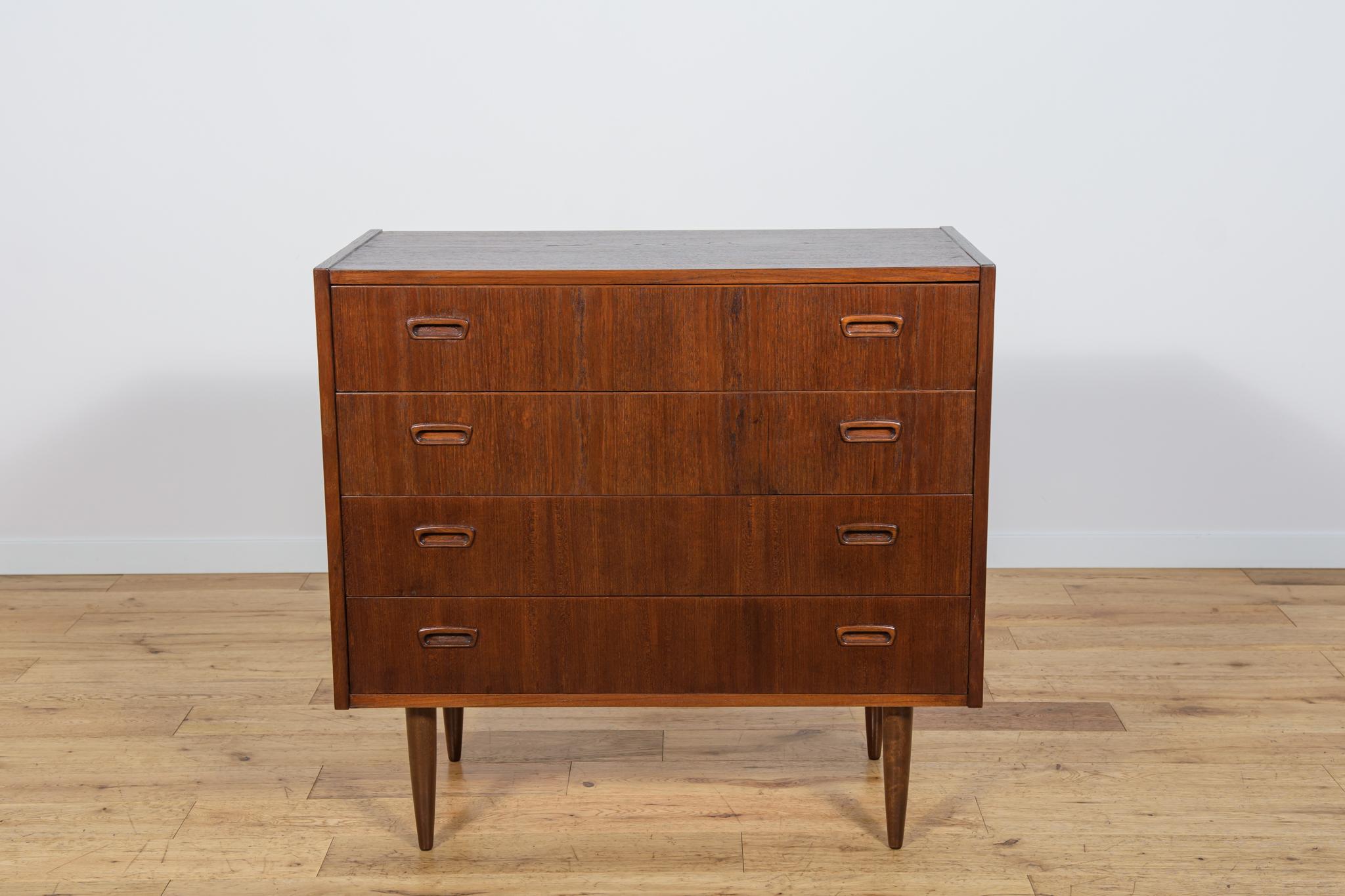 Mid-Century teak dresser made and manufactured during the 1960s in the Denmark. The dresser has profiled handles. The dresser consists of 4 drawers with profiled handles. Teak wood items cleaned from the old surface, painted rosewood stain and