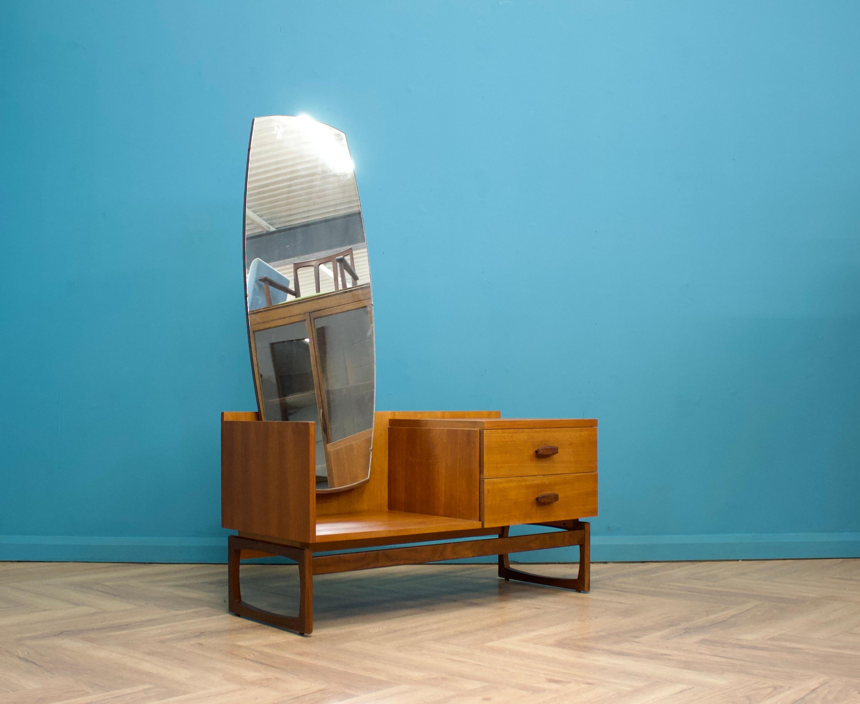 A mid century teak dressing chest by G Plan from the Quadrille range  - circa 1960s
Standing on sleigh legs
It features a full length mirror and two drawers


Height up to the mirror is 157cm

