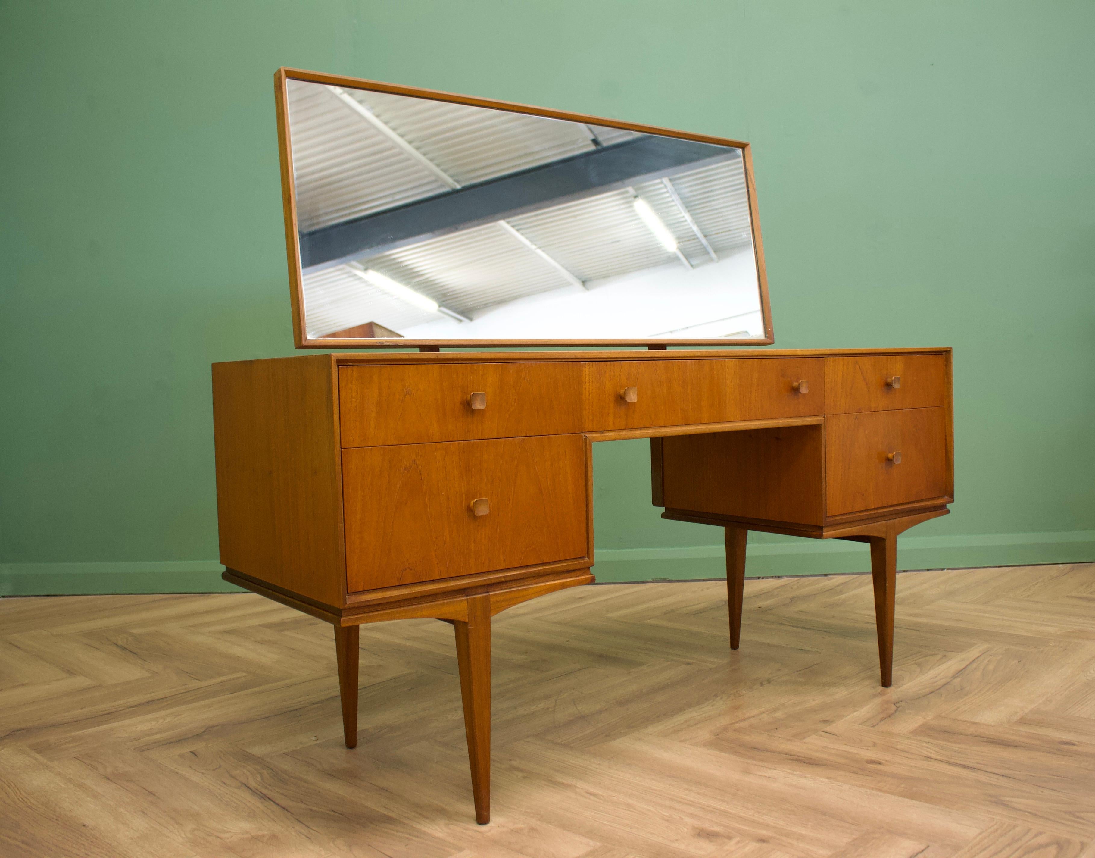 - Mid century dressing table and stool
- Manufactured in the UK by McIntosh
- Made from Teak & Teak Veneer.

- Featuring 5 drawers.