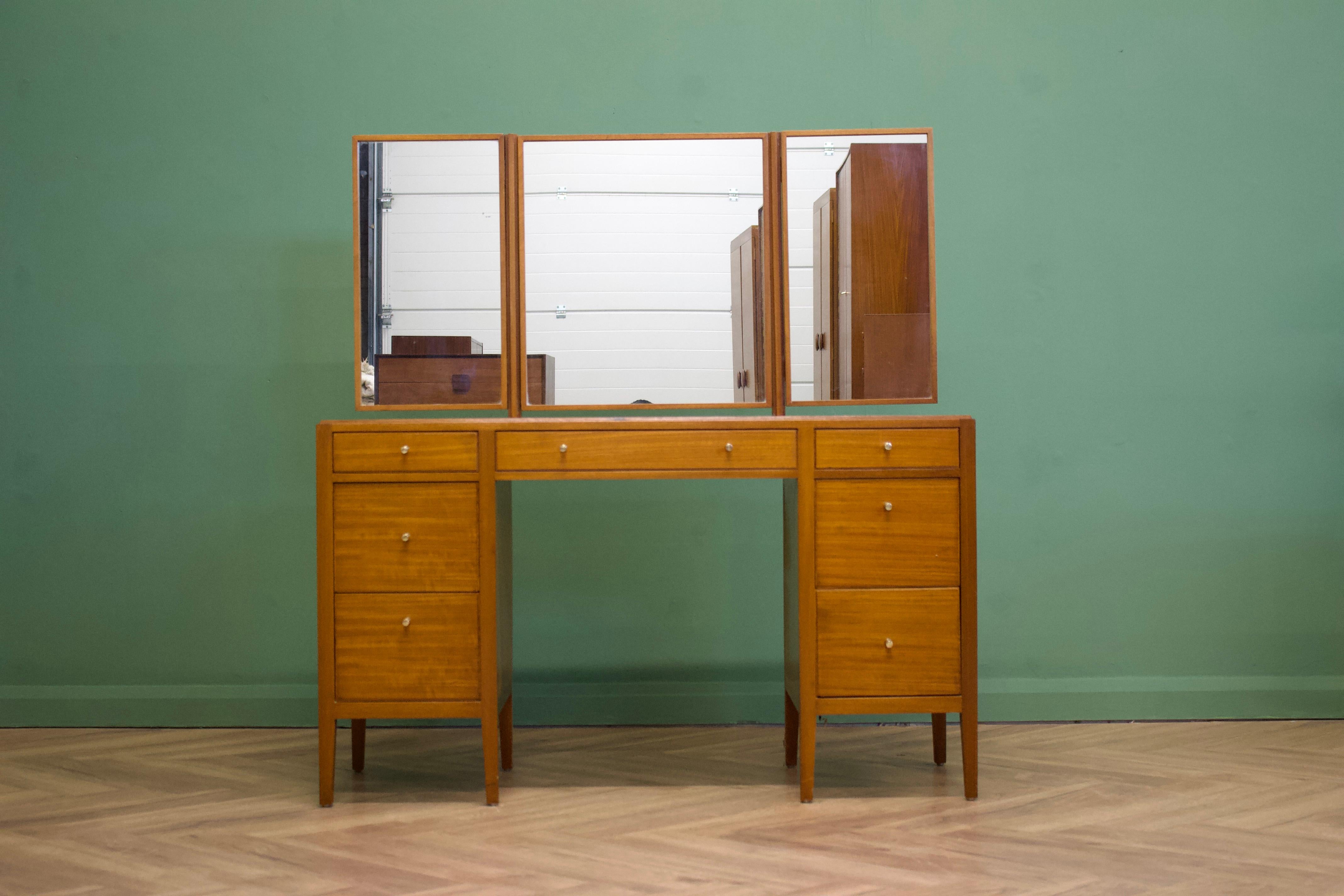 - Mid-century dressing table.
- Manufactured in the UK by Loughborough
- Retailed through the department store Heals, during the 1960s
- Made from Teak & Teak Veneer.

- Featuring 7 drawers and a triptych mirror.
