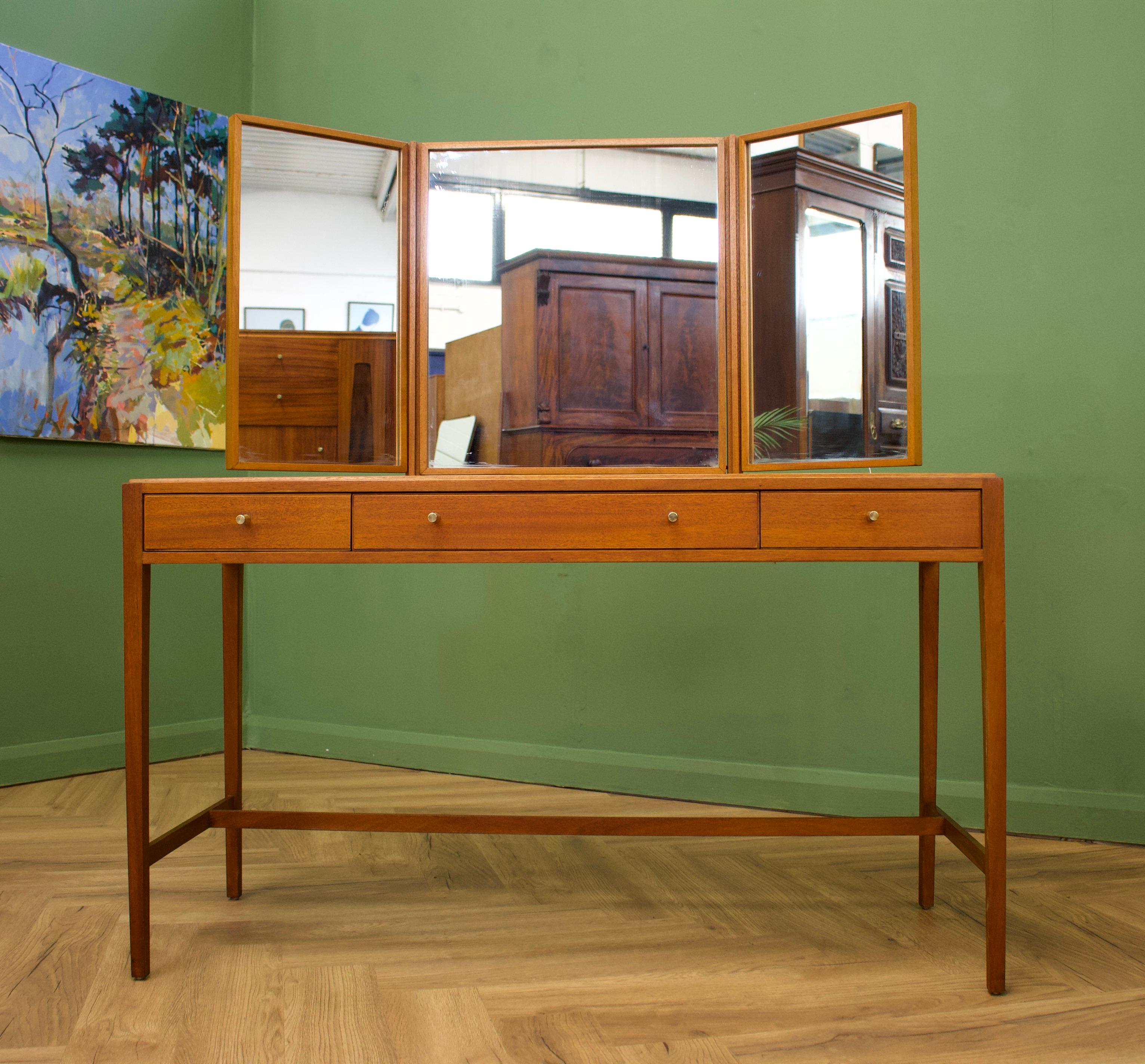 - midcentury dressing table.
- Manufactured in the UK by Loughborough
- Retailed through the department store Heals, during the 1960s
- Made from Teak & Teak Veneer.

- Featuring 3 drawers and a triptych mirror.
