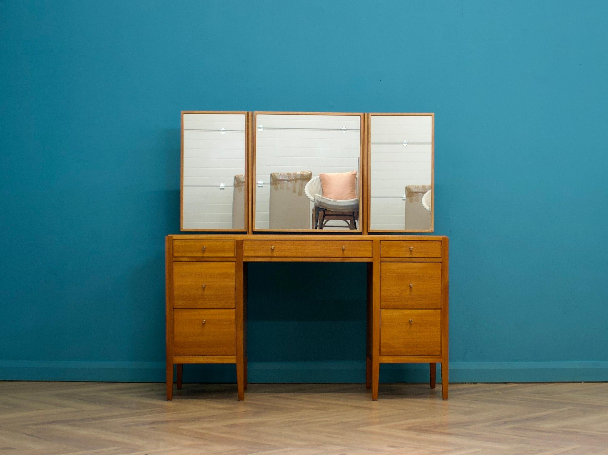 A mid century teak & mahogany dressing table from Loughborough, circa 1960's - these pieces from Loughborough were usually retailed through Heals department store
Complete with a triptych mirror - the middle tilts, the two side mirror's swivel
There