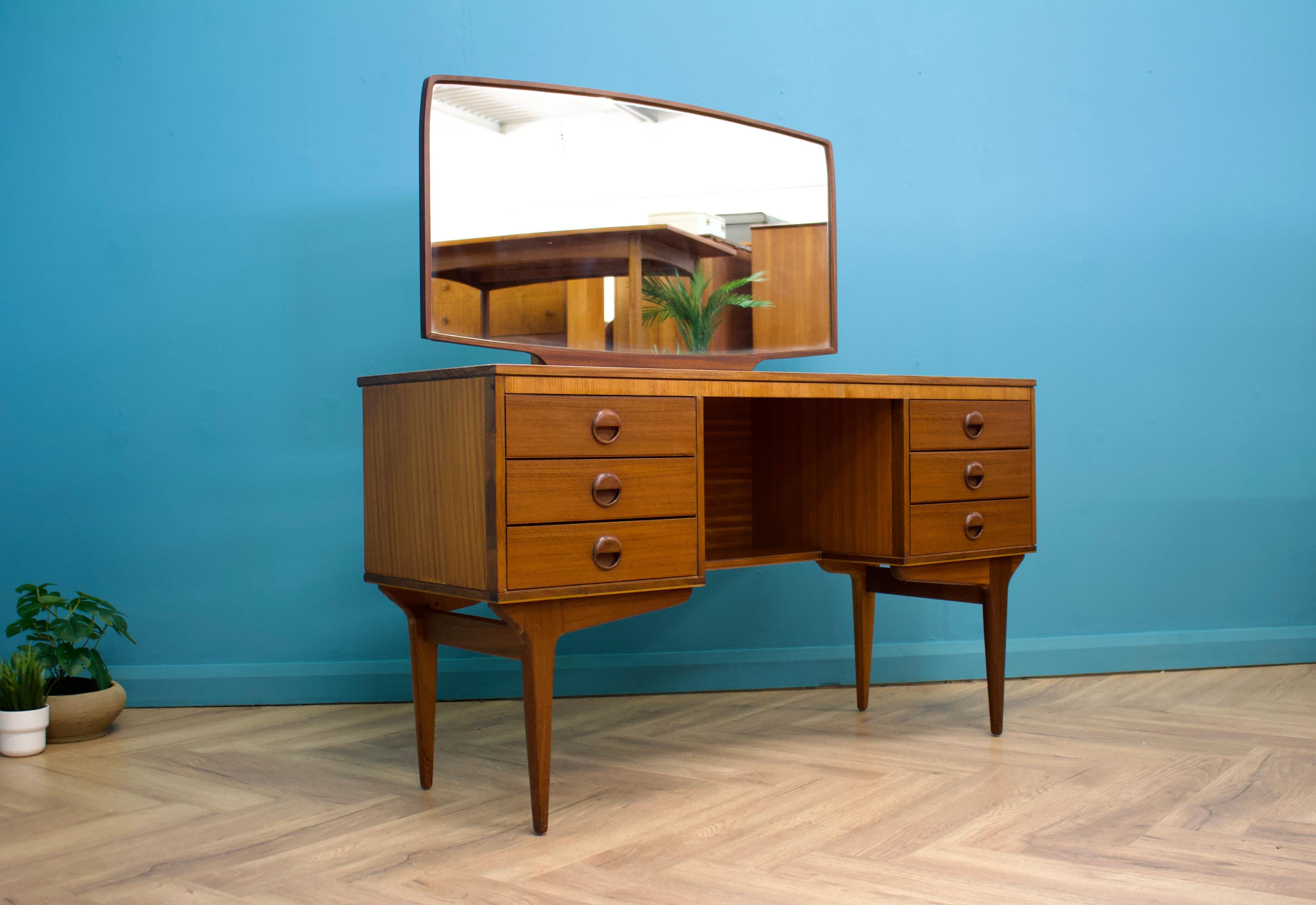 A mid century teak dressing table from Butilux - a little known about  high quality furniture makers, circa 1960's
There are six drawers in total

Height to the top of the mirror is 132 cm
