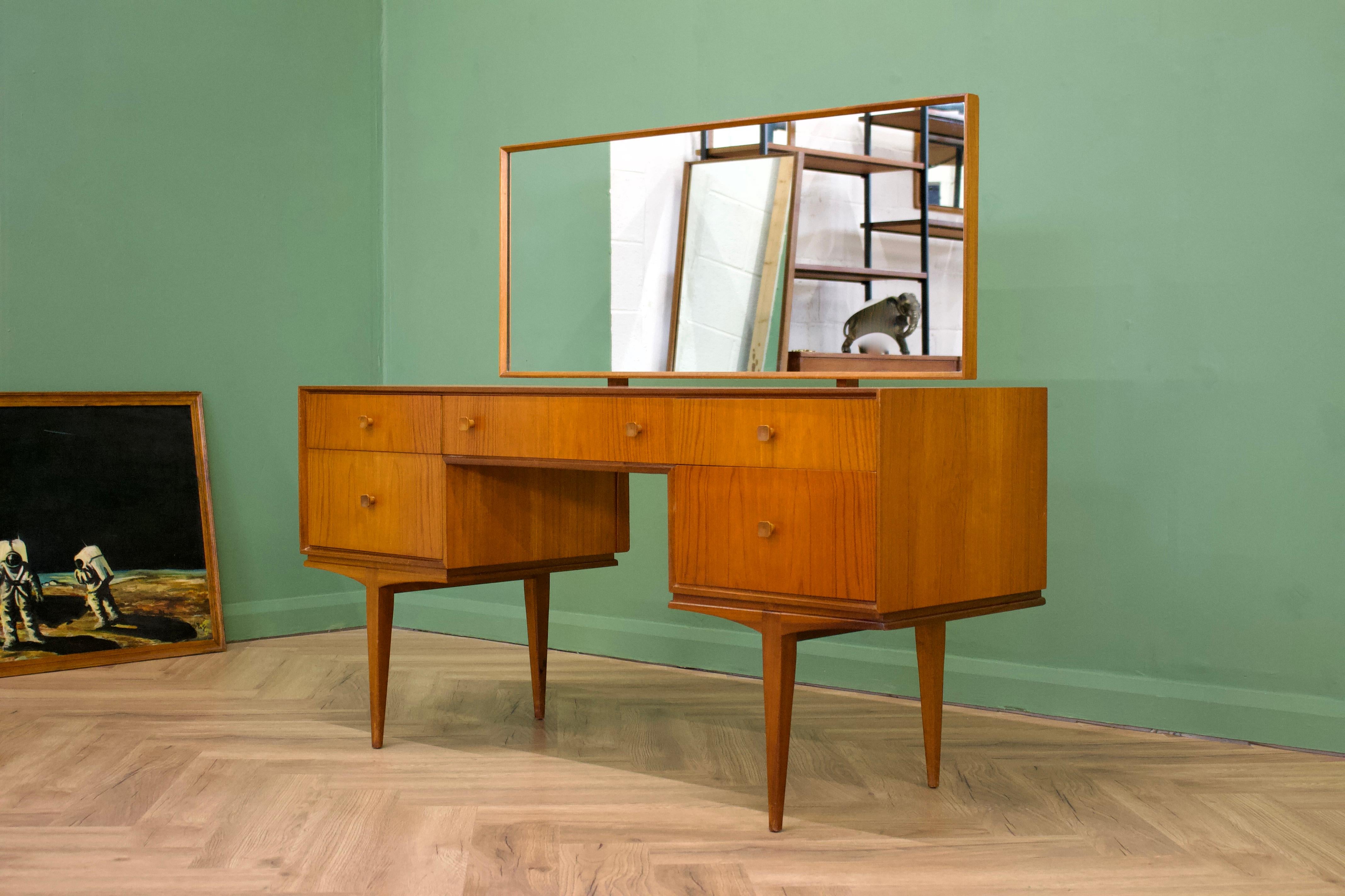 - Mid century dressing table 
- Manufactured in the UK by McIntosh
- Made from Teak & Teak Veneer.

- Featuring 5 drawers.