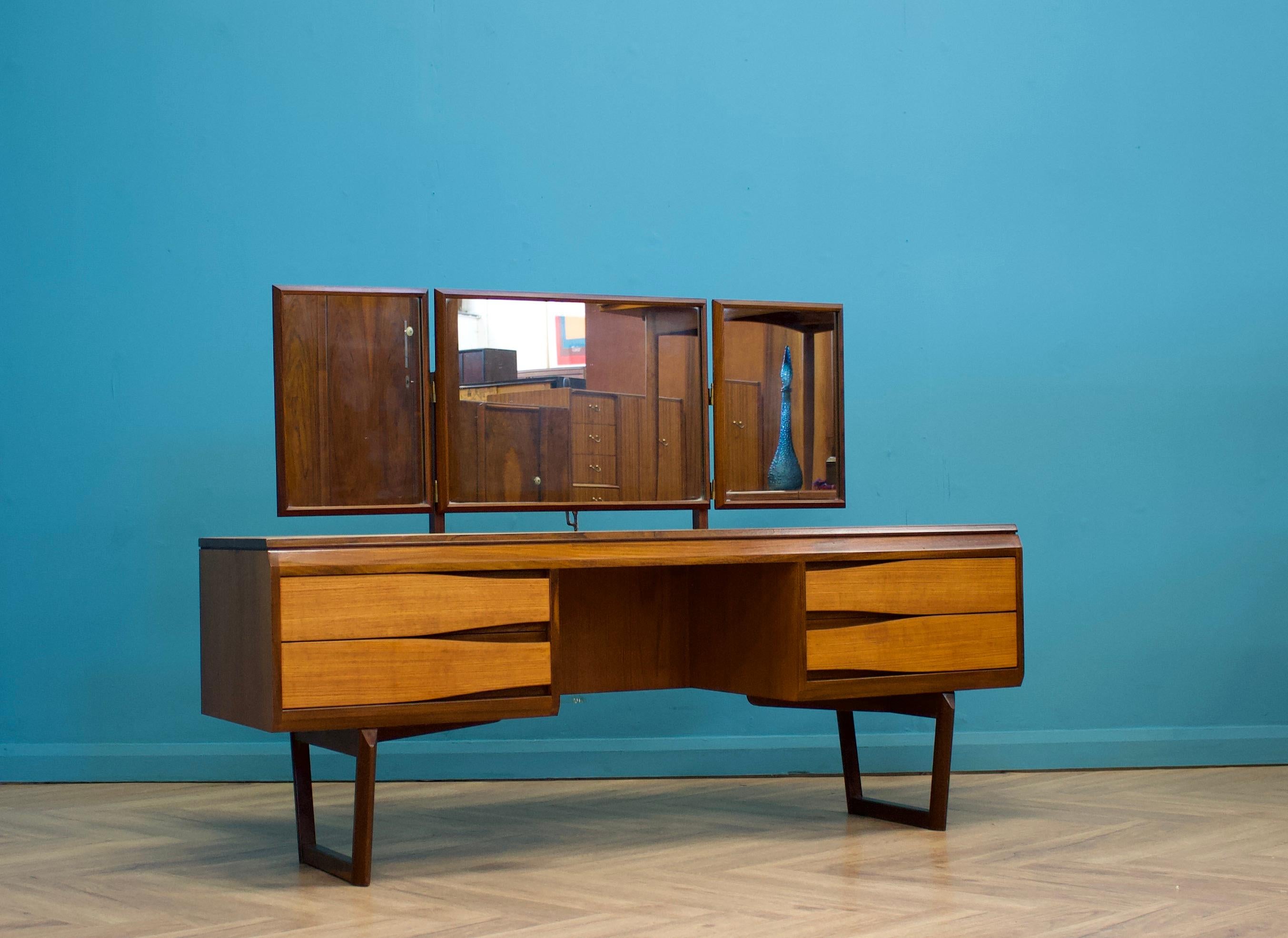 - Mid century dressing table & stool
- Manufactured in UK by White & Newton
- With triptych mirror and four drawers
- Made from teak and teak veneers
- Height to top of mirror is 113cm.

- In the manner of Arne Vodder