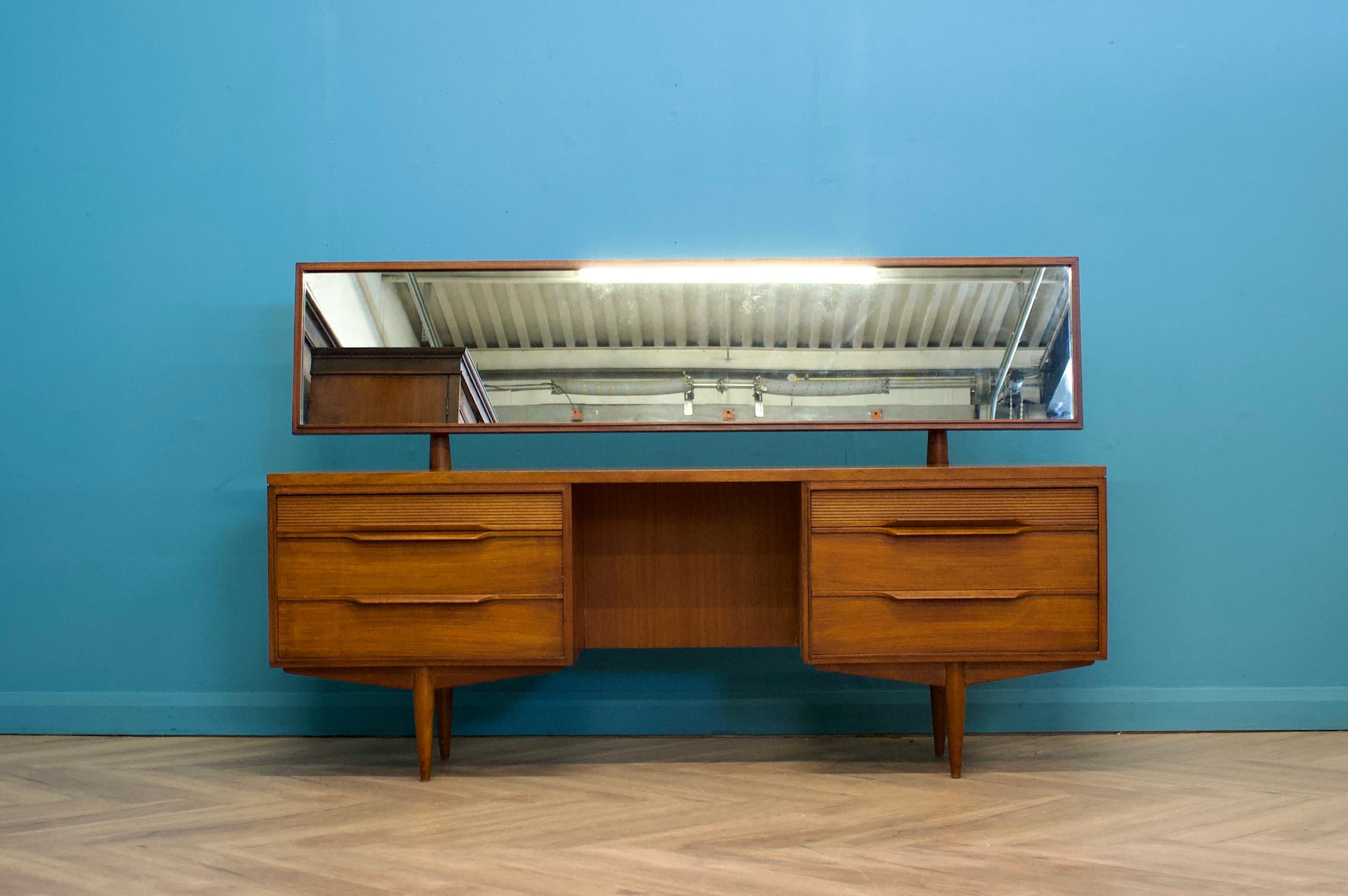 - Mid century dressing table & stool
- Manufactured in UK by White & Newton
- With Mirror and six drawers
- Made from teak and teak veneers
- Height to top of mirror is 108cm
.