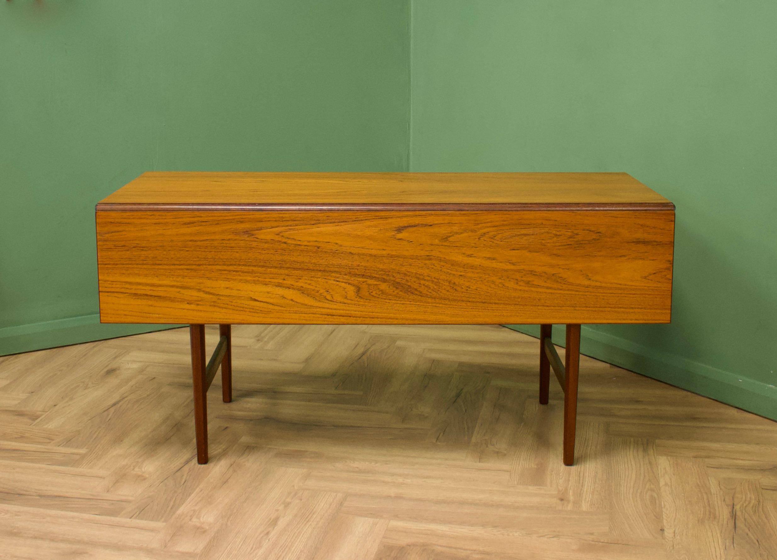 A teak fold down dining table made by Bath Cabinet Makers, circa 1960s
This table has a great space saving design

Extended depth 92 cm