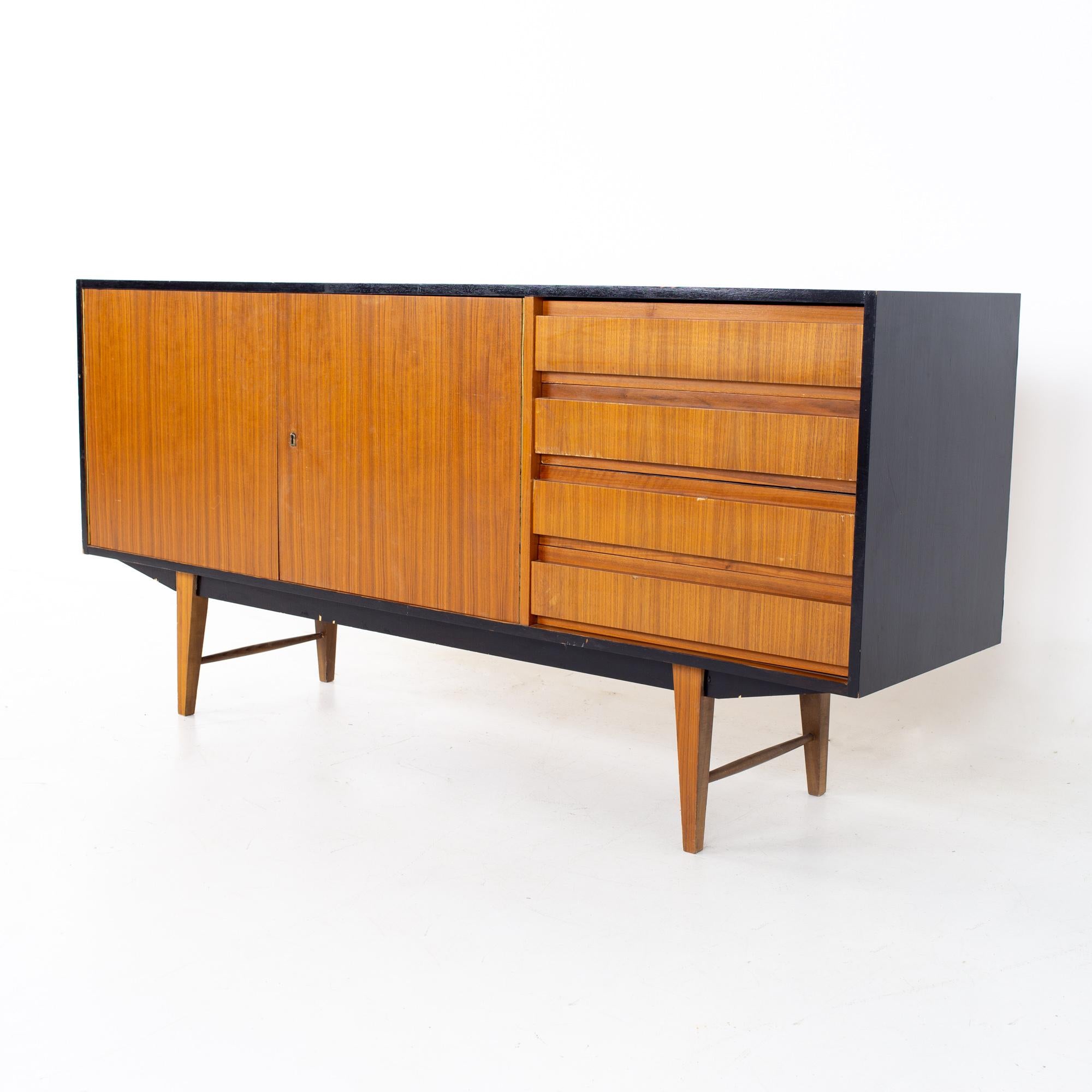 Mid century teak ebonized credenza
Credenza measures: 65 wide x 17.75 deep x 31.5 inches high

All pieces of furniture can be had in what we call restored vintage condition. That means the piece is restored upon purchase so it’s free of