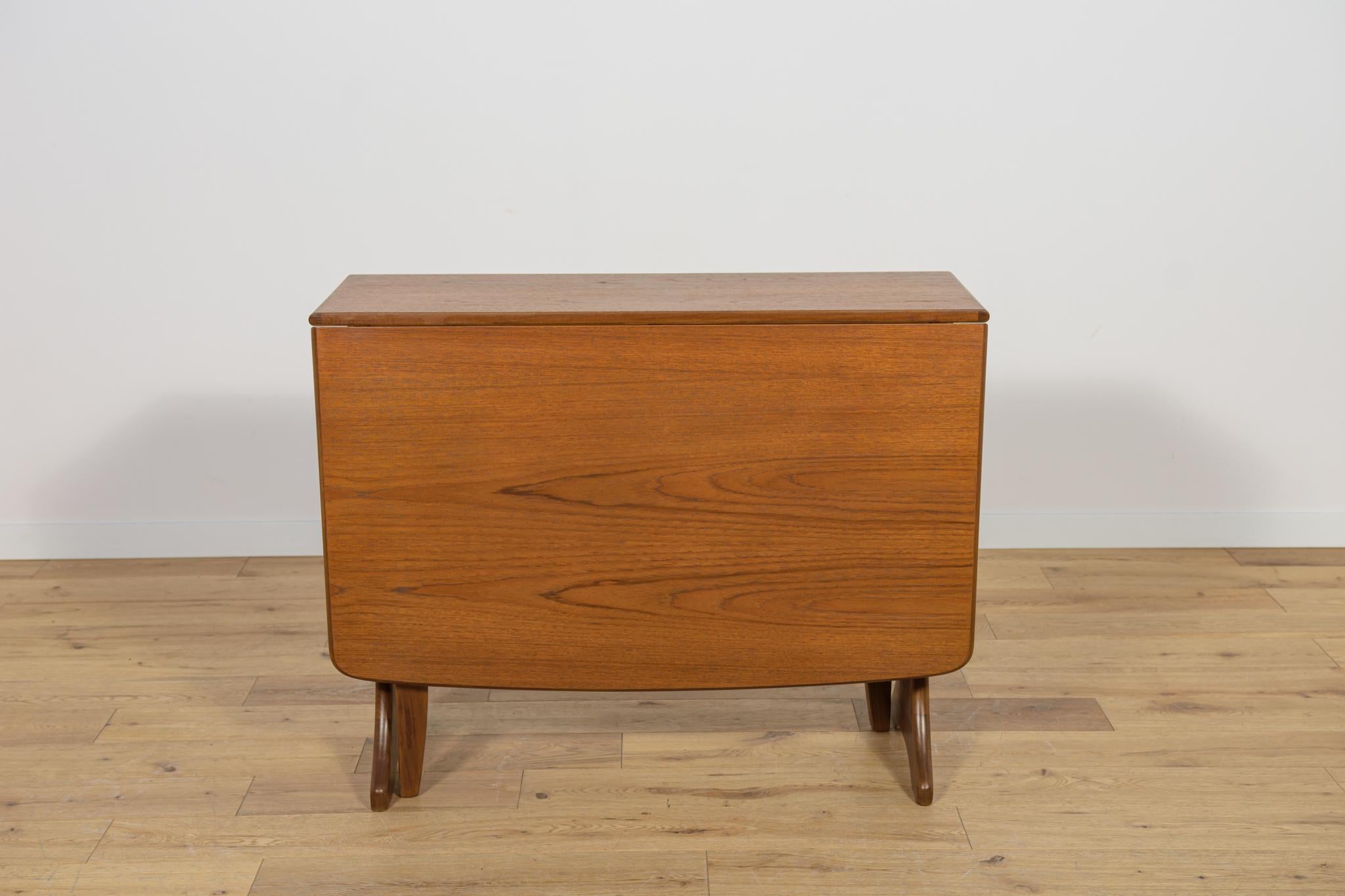 This dining table in teak dates from the 1960s. The table manufactured by G-Plan in United Knigdom. The teak elements have been cleaned from the old surface and painted oak stain, finished with a strong semi-gloss lacquer. Before unfolding, the