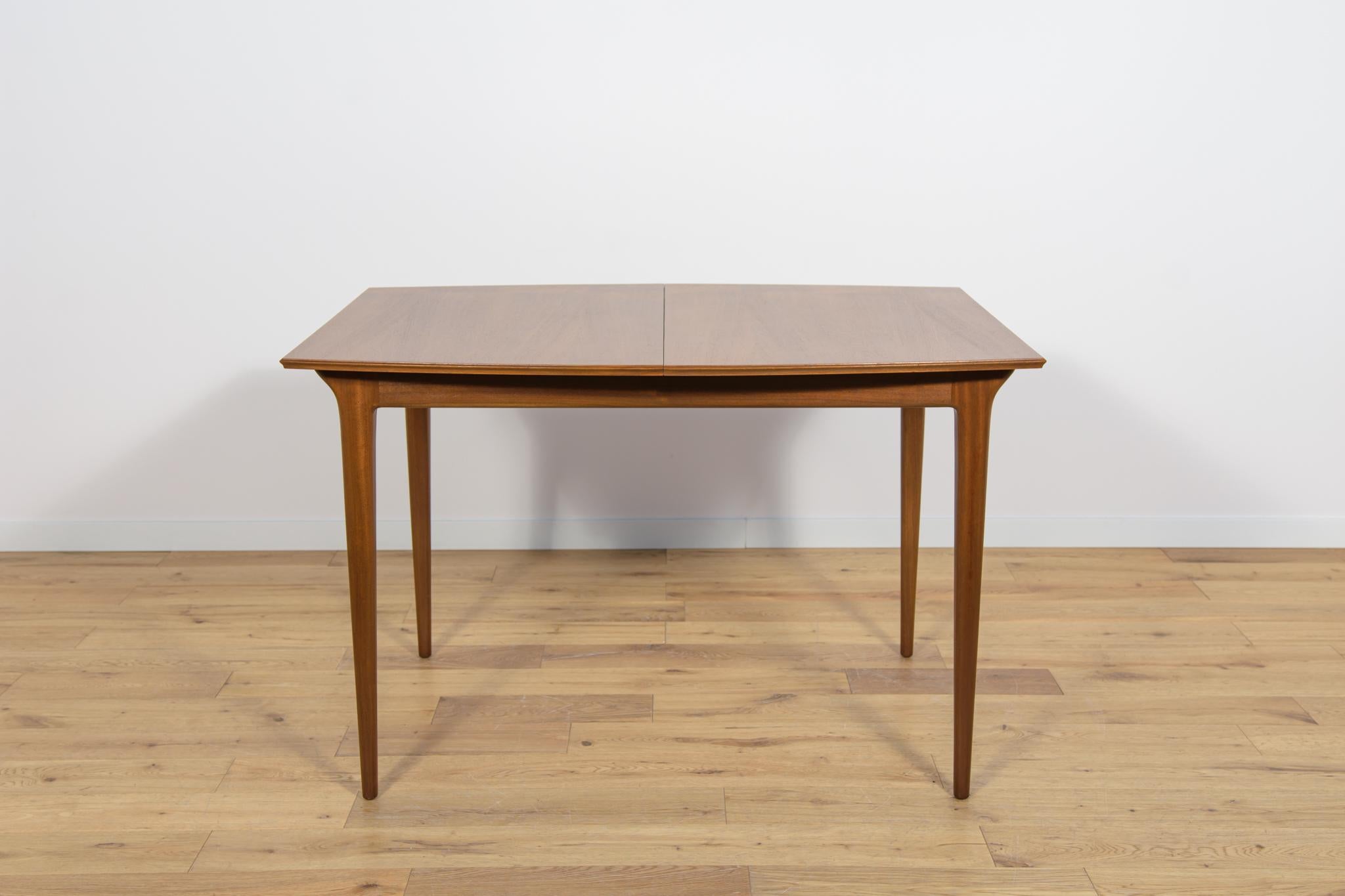The table produced in the 1960s in Scotland by A.H. McIntosh. It is made from teak. The furniture has profiled legs, giving it a unique character and elegance The old surface has been cleaned, painted in oak stain and polished with strong a