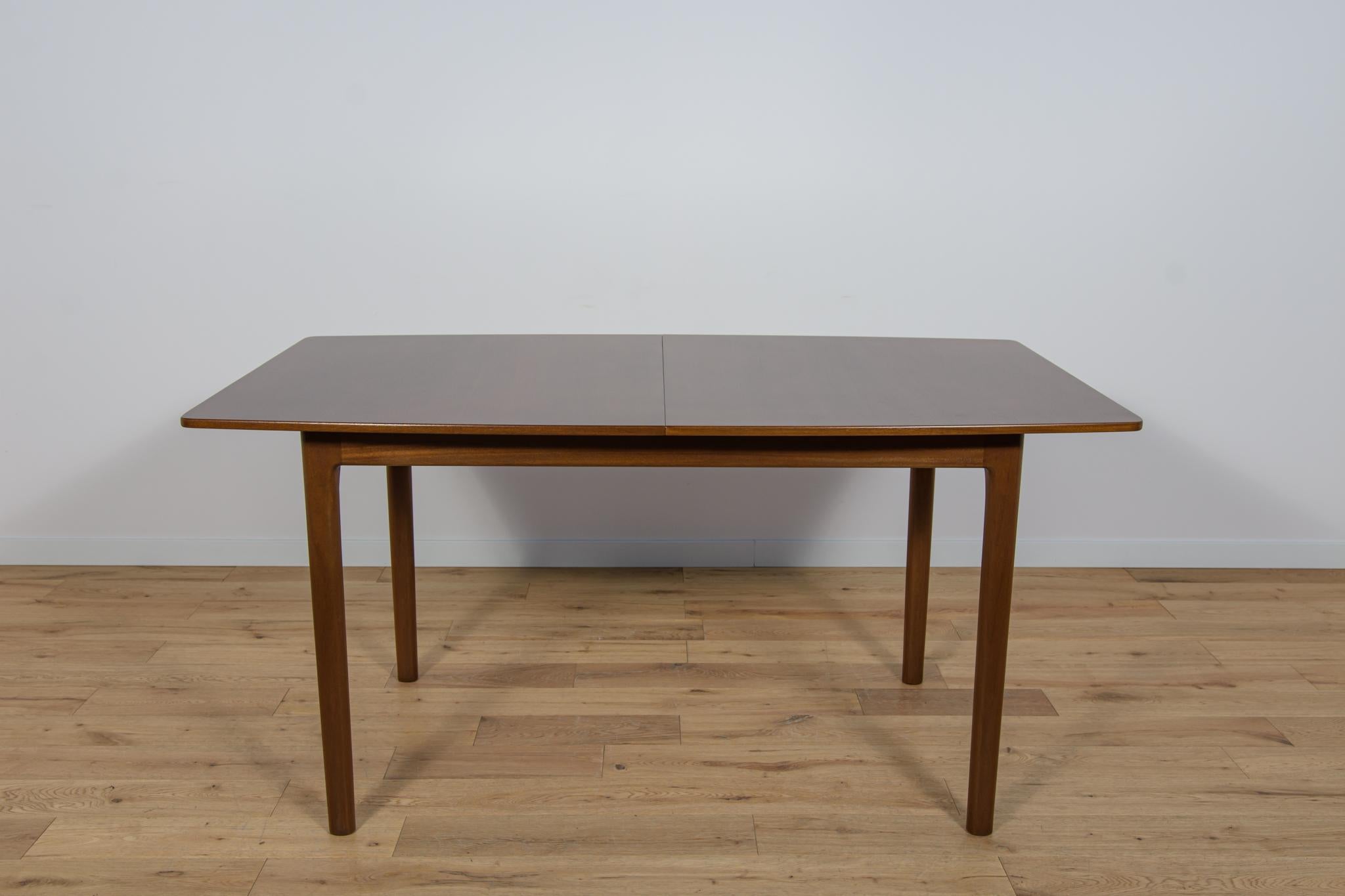 The table produced in the 1960s in Scotland by A.H. McIntosh. It is made from teak.  The old surface has been cleaned, painted in oak stain and finoished with strong a semi-matt lacquer. The table has a mechanism that makes it easy to extend from
