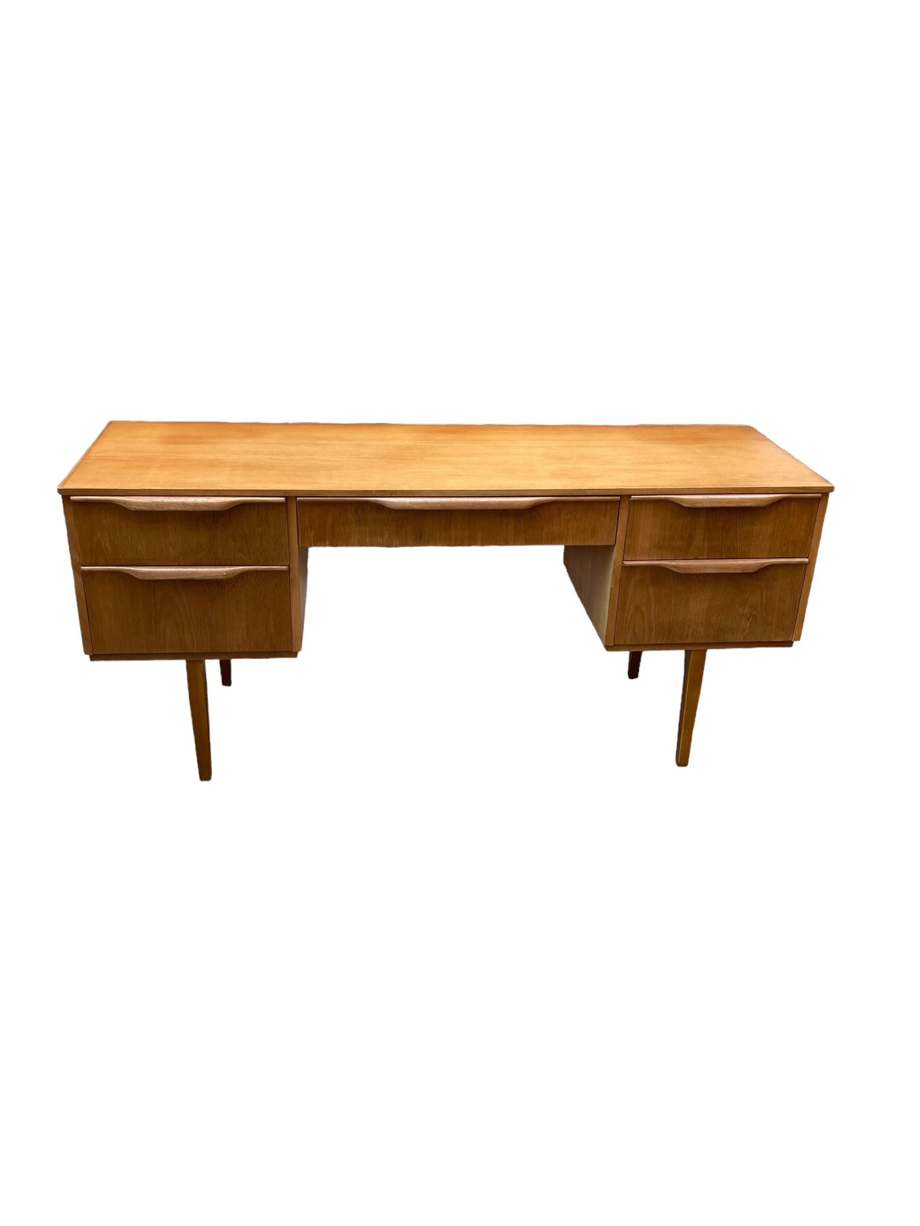 Mid Century Teak Five Drawer Austinsuite Low Desk/Dresser, Danish style on four Pin legs. This classic sleek design is both stylish and practical and fits into any theme of design
H: 68cm
L: 147cm
D: 48cmt
Desk knee hole Height: 55cm
Desk knee hole