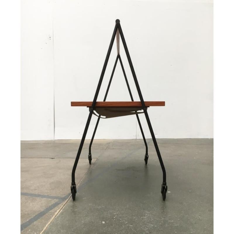 Elegant teak tea trolley with striking shape and finely executed details.

Especially eye-catching is the elegant A-shape of the frame, which is completely in black. The teak elements, the shelf, and the handle form a wonderful contrast. The