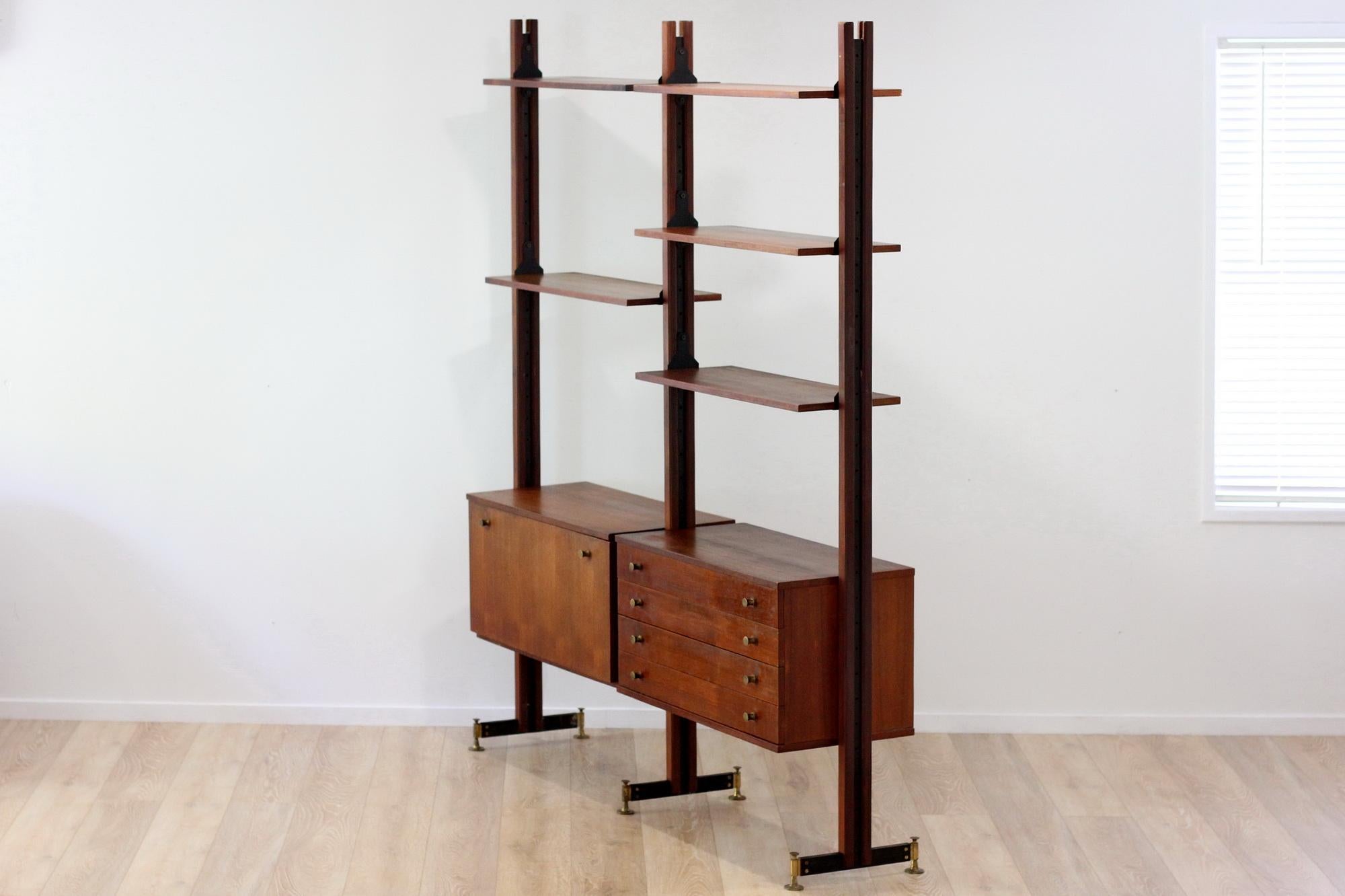 Mid century 2-bay Teak wall units in fair used condition.

Measures: 215H * 172W * 42D

All the shelves and cabinets are adjustable, can be put in any position.

The most fascinating thing about modular system is that the final design is left