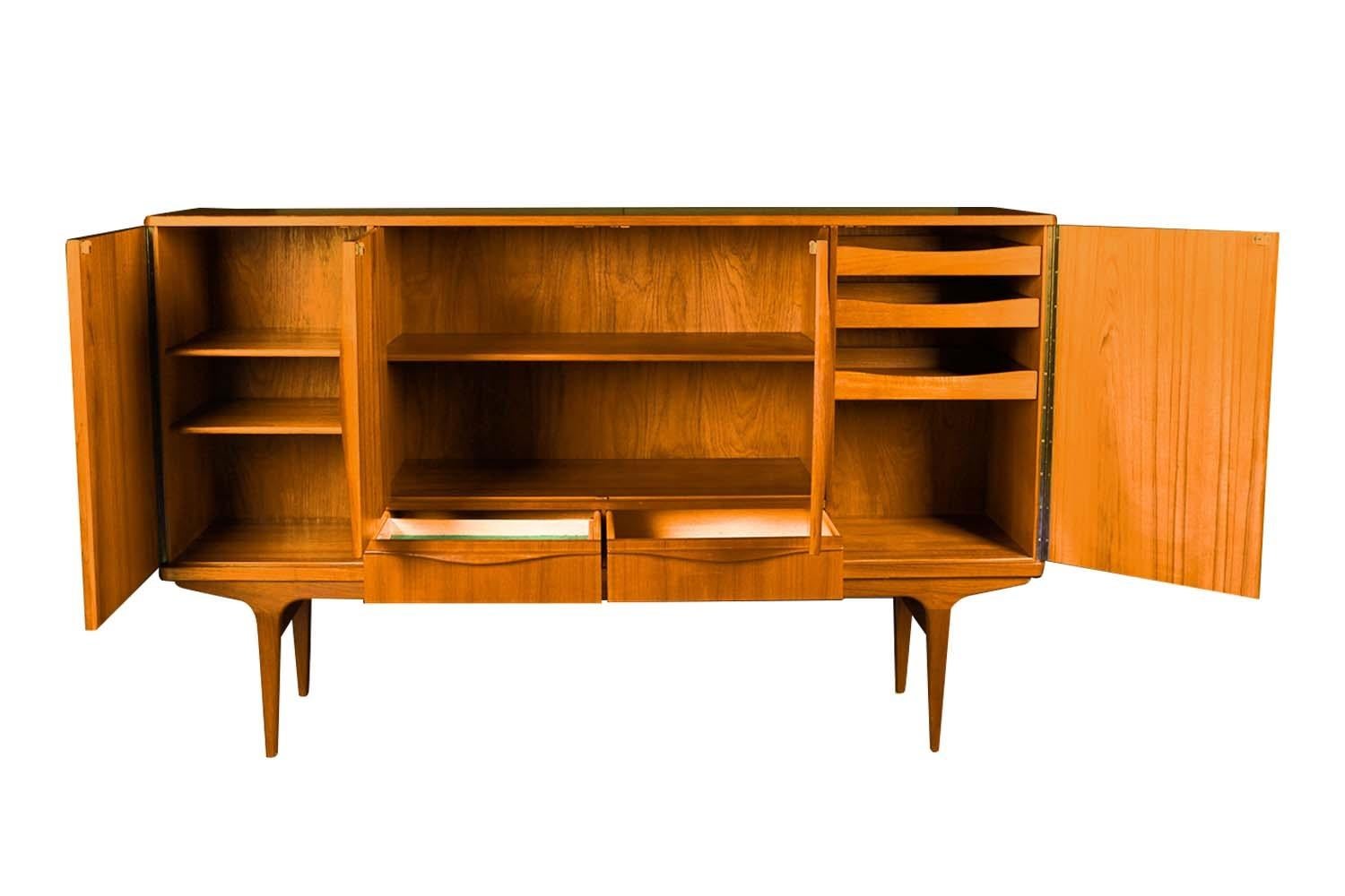 Exceptional Mid Century extra tall teak highboard sideboard/ server made in Denmark, by LYBY Mobler circa 1960’s. Beautifully teak grained, extra tall sideboard. Features finished teak interior with spacious storage in the center flanked by cabinet
