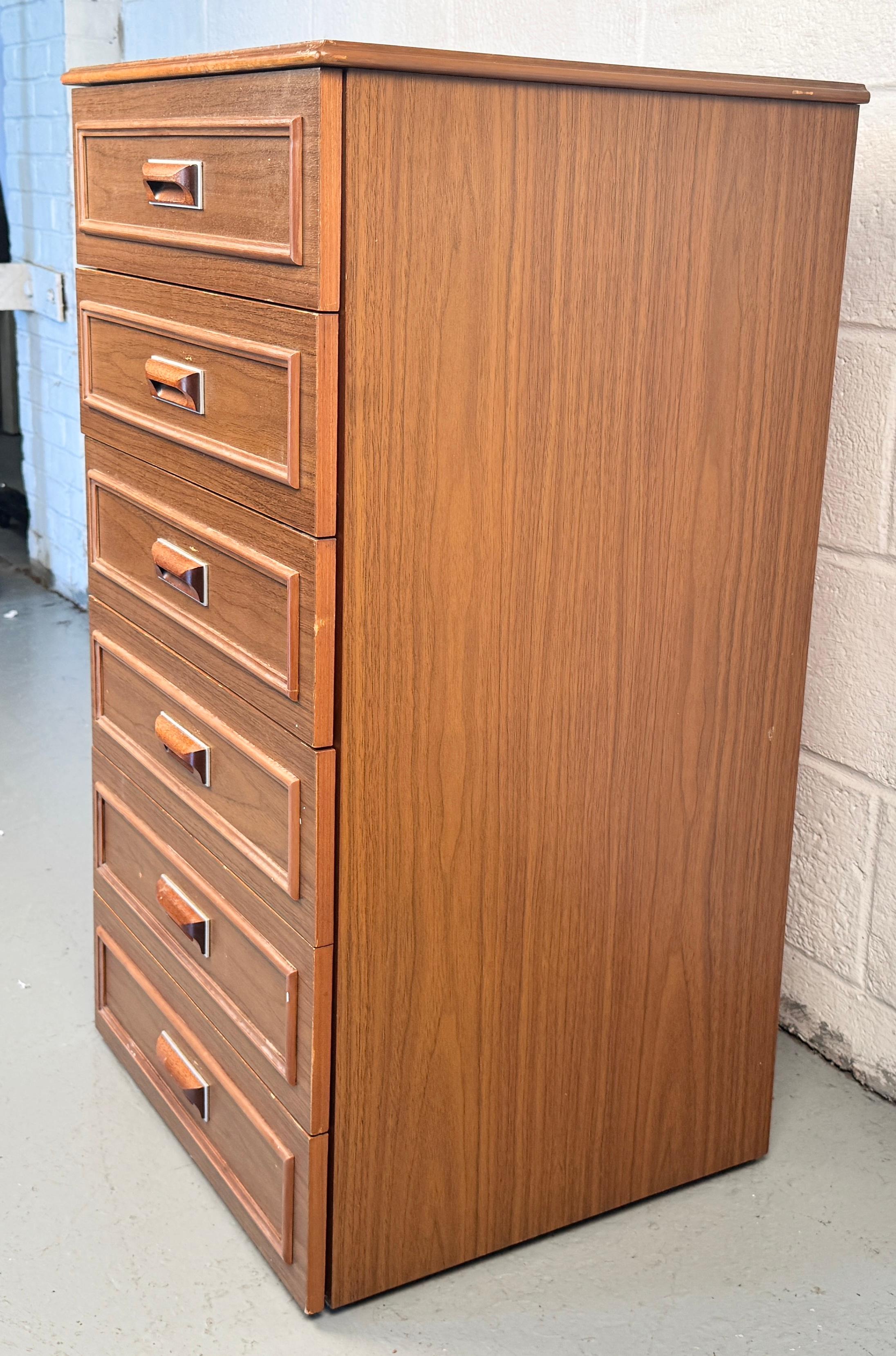 Crafted in the 1960s–70s by Europa, this highboy dresser exemplifies the best of Mid‑Century Modern design—clean lines, warm teak tones, and functional elegance.

Please confirm location with seller (NY or NJ).