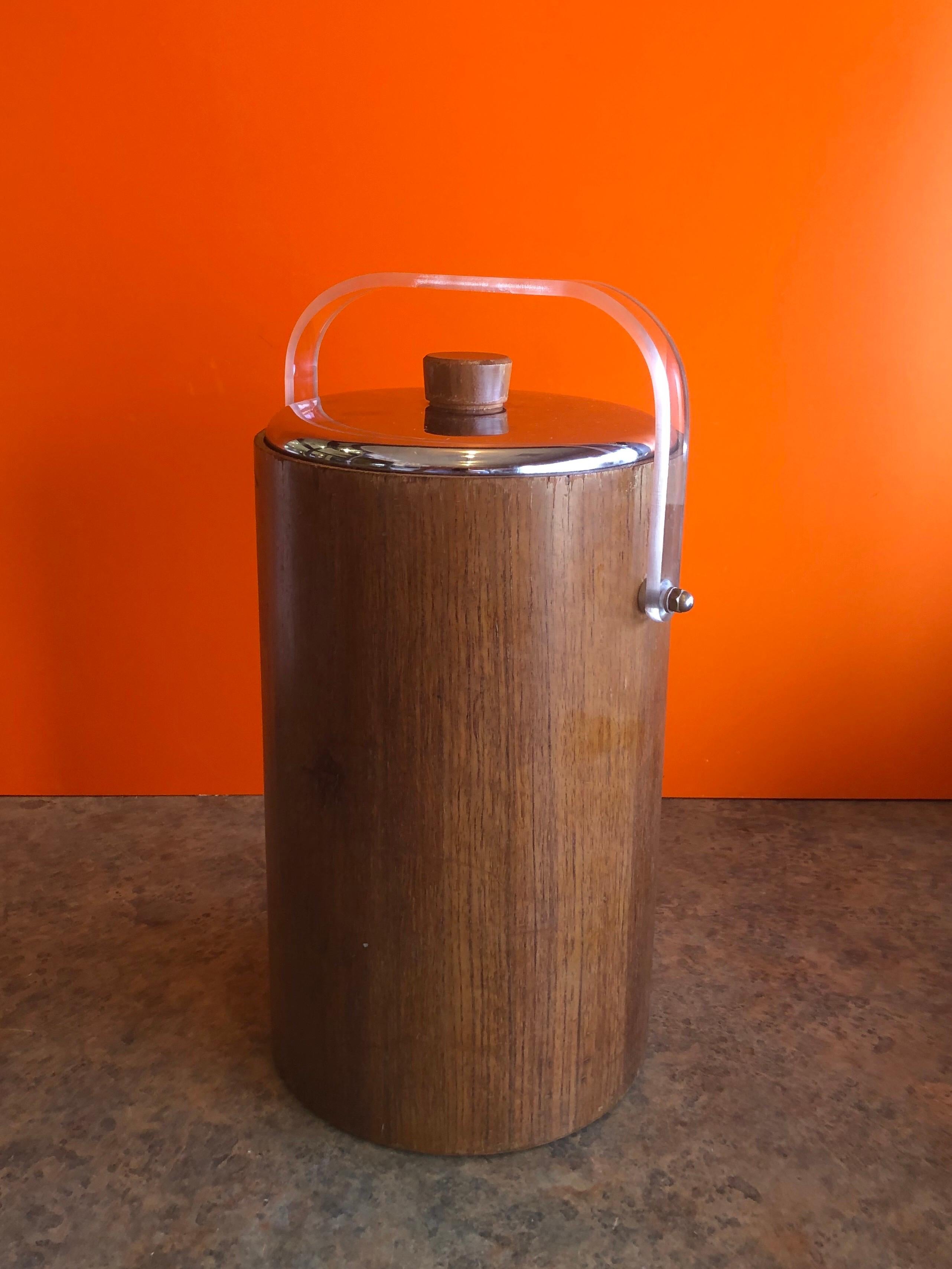 A very nice large midcentury teak ice bucket with Thermos glass liner, chrome lid and acrylic handle by The American Thermos Bottle Co, circa 1960s. The piece is very solid and sturdy piece that is also hard to find due to the glass Thermos liner.