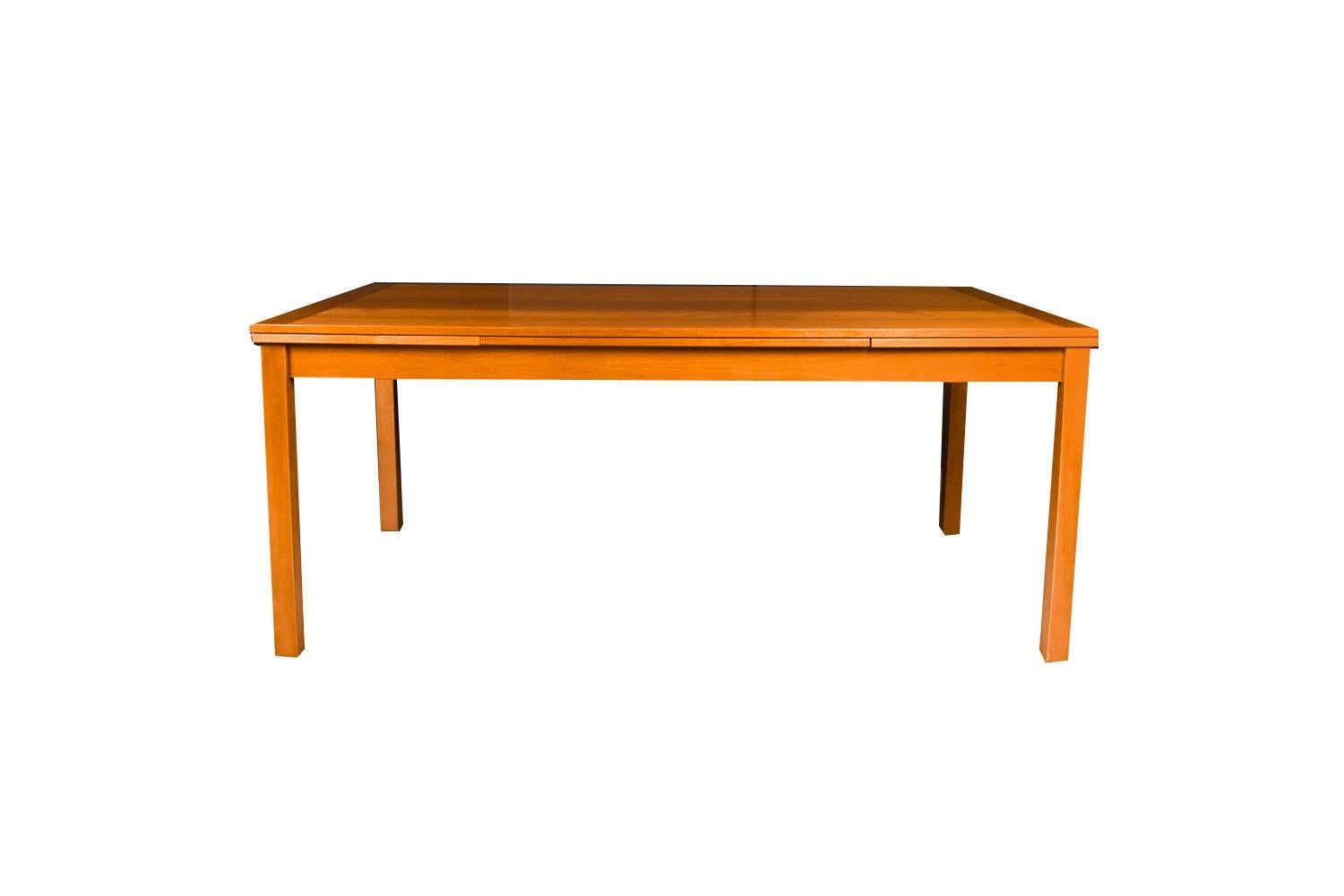 An exceptional Danish Modern teak extension dining table by Ansager Mobler made in Denmark. With an initial large footprint, this table can also offer a generous space and double in size once its hidden draw leaves are extended. Amazing design and