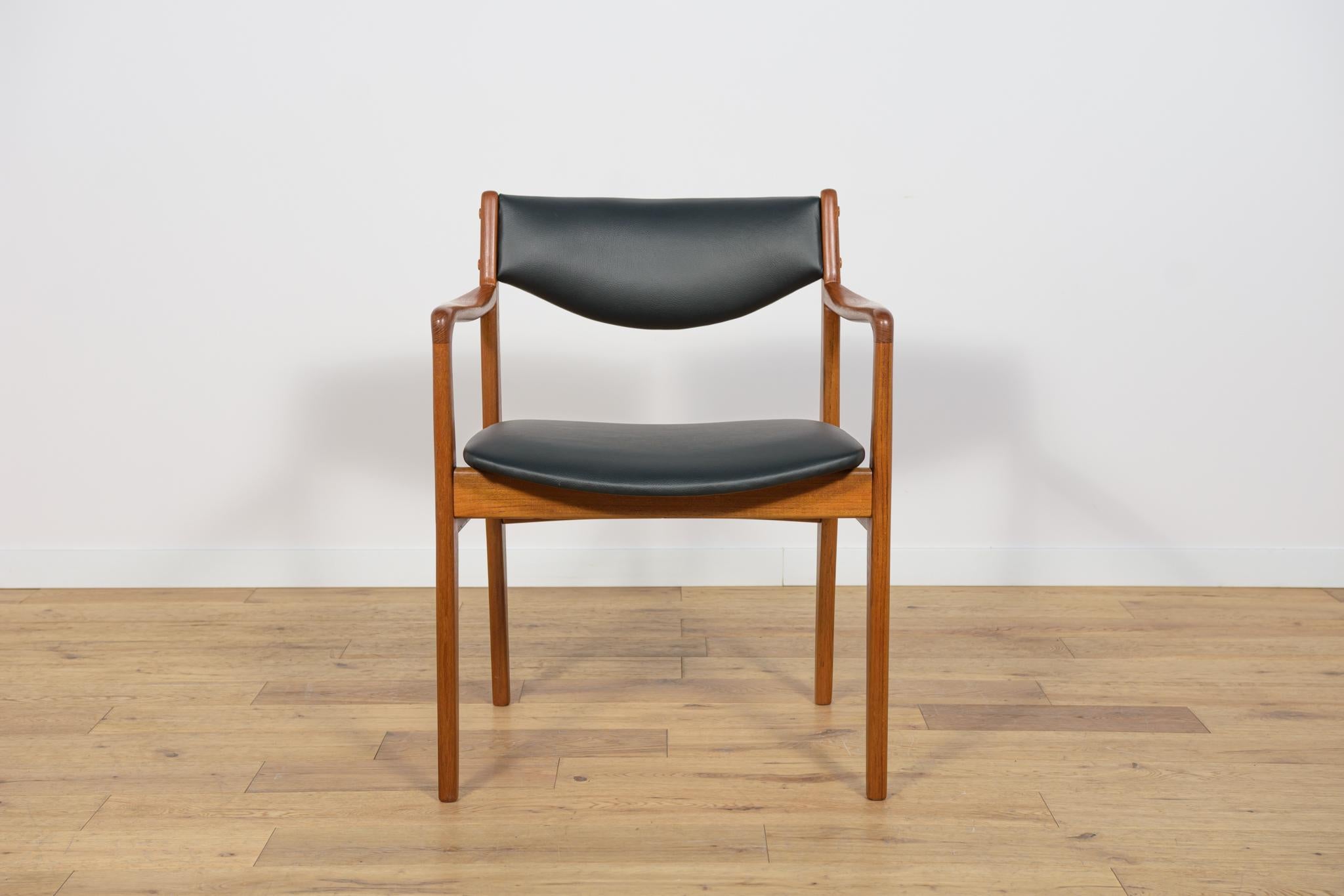 The armchair made of teak wood in Denmark in the 1960s. An armchair with an interesting form, characterized by profiled armrests. The piece of furniture has undergone comprehensive carpentry and upholstery renovation. Wooden elements cleaned of old