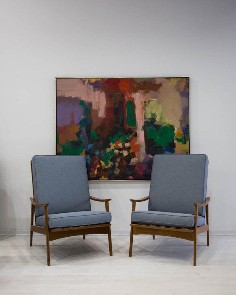 A beautifully restored pair of midcentury teak lounge chairs featuring a sculptural silhouette that is attractive from all angles. 

The frames have been fully refinished; the cushions have new foam and are upholstered in a luxe upholstery grade