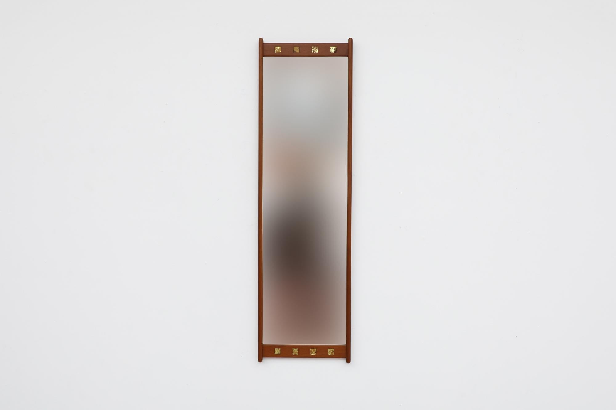1950s teak wall mounted mirror by Fröseke AB Nybrofabriken. The frame is made from solid teak with decorative glass squares lining the top and bottom of mirror. In original condition with some visible wear consistent with its age and use. Other