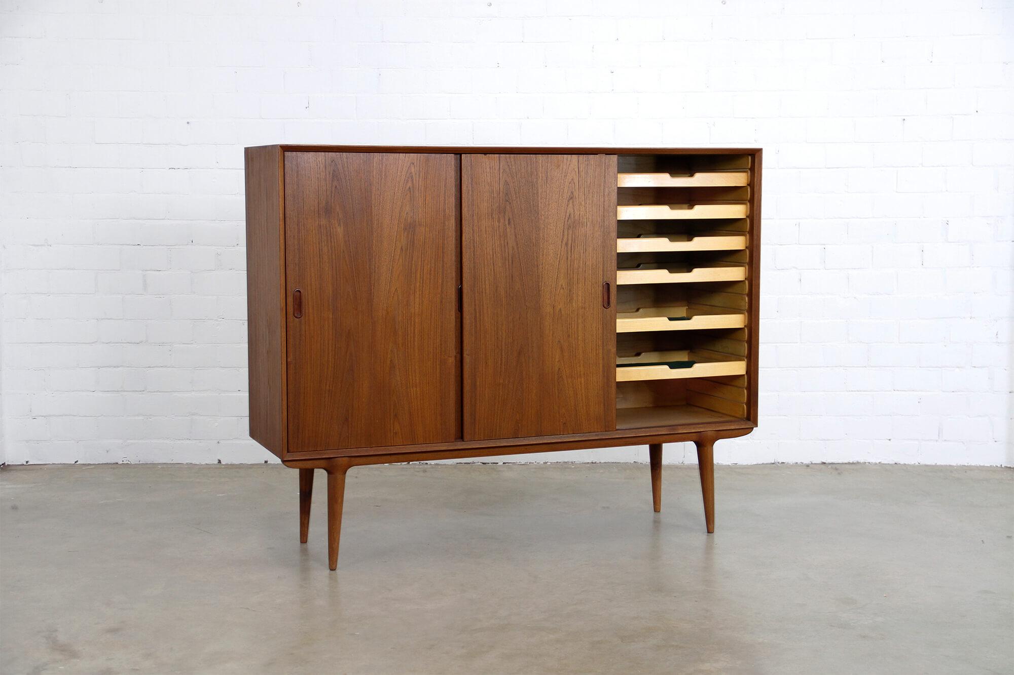 This beautiful Model 5 highboard was designed for Omann Jun Møbelfabrik in Denmark, 1960s. The sideboard has three sliding doors and integrated drawers finished in teak.