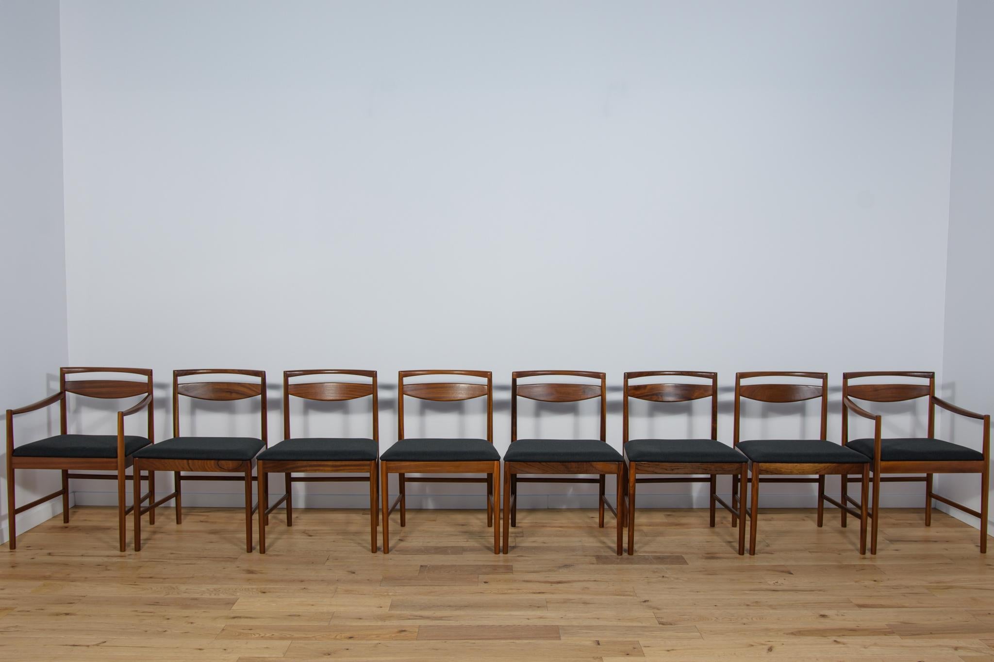 A pair of two armchairs and six chairs Model 9513 designed in 1972 by Tom Robertson for the British manufacturer McIntosh. The chairs have a minimalist Japanese-style frame with organic rounded edges. The set is made of teak wood and has been