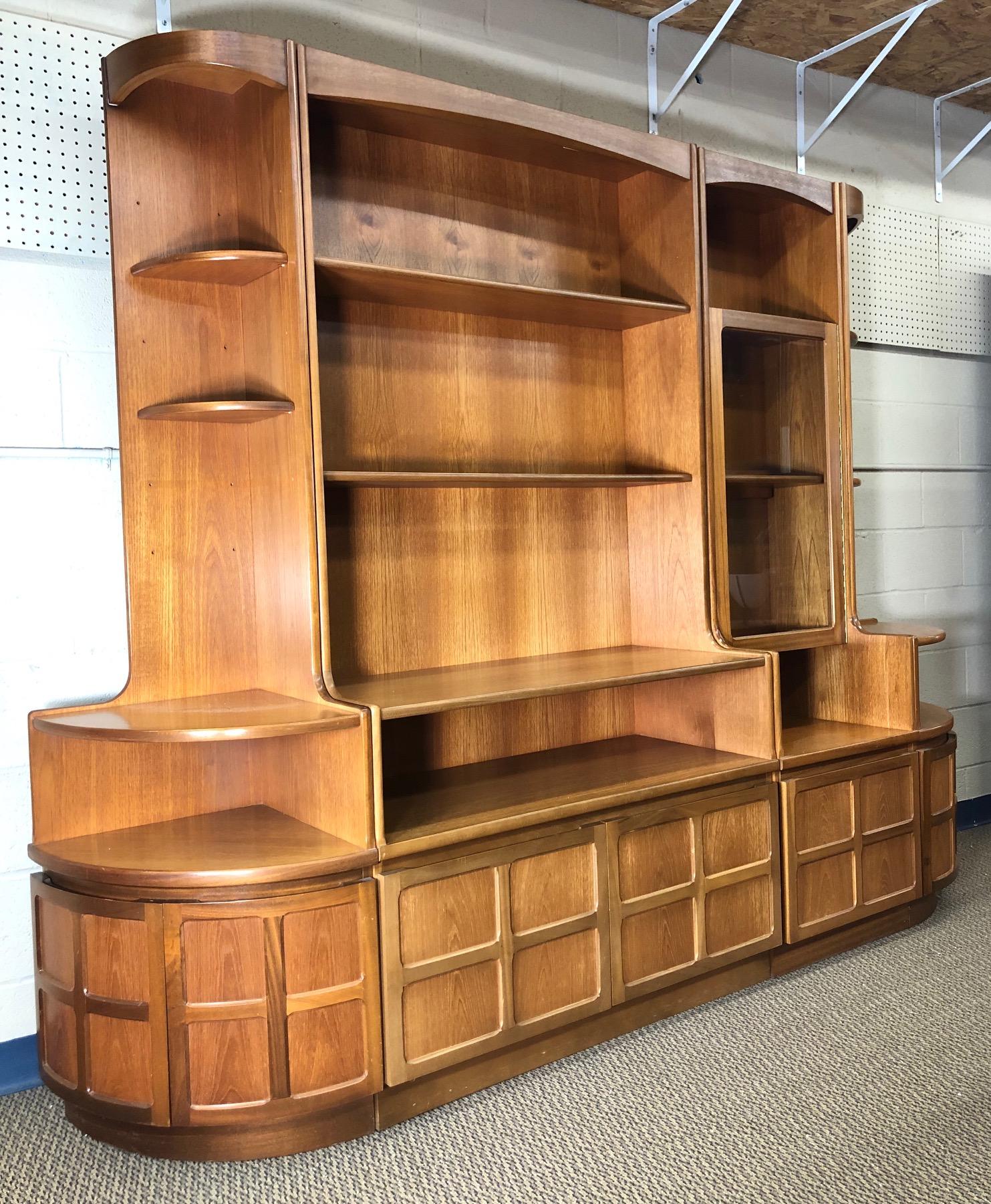 Fantastic teak wall unit made by Nathan Furniture. Made in England.

Features 2 smaller corner units and 2 main units. The corner shelves are adjustable. Original labels and tags are attached. The indivdual units may have been purchased a