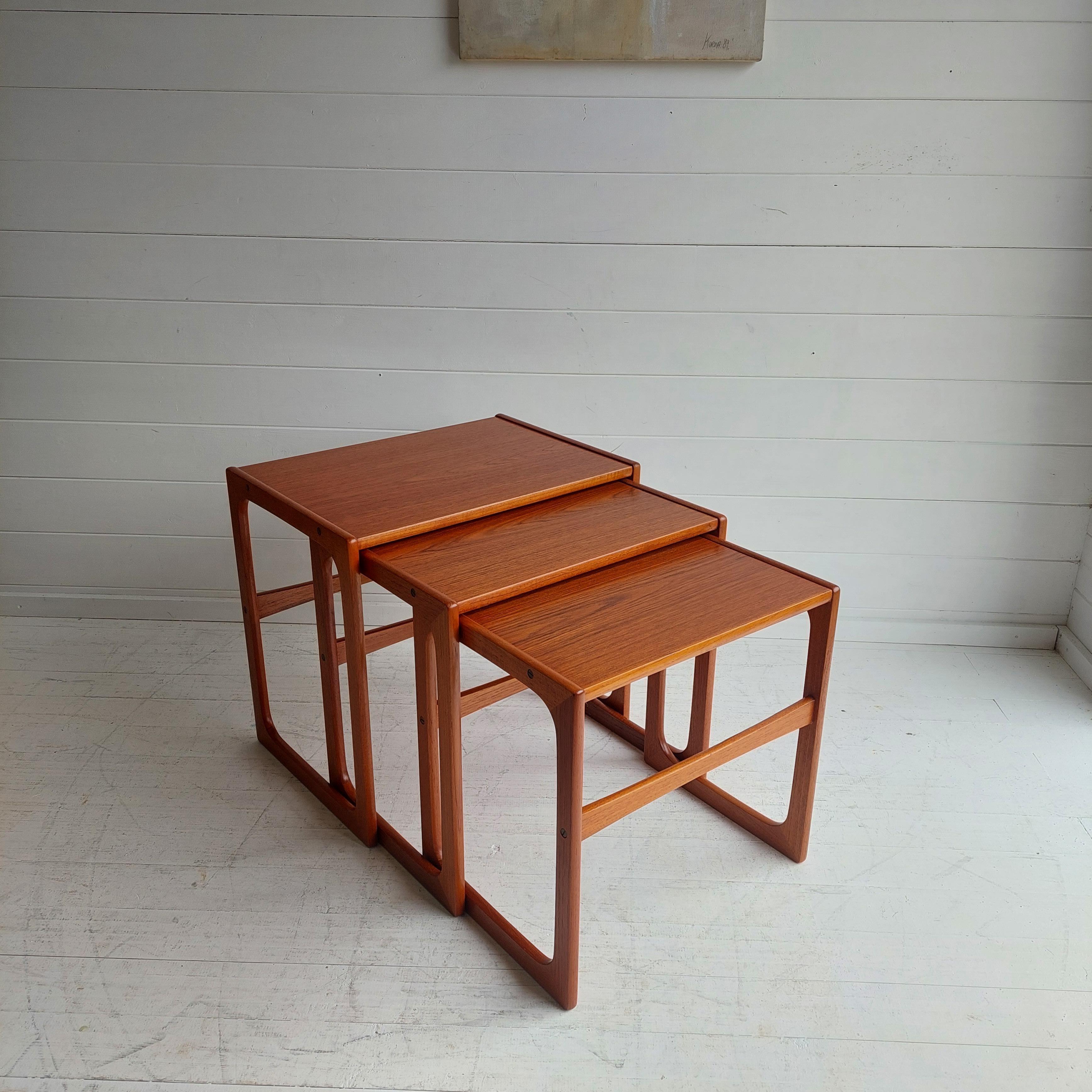 Lovely set of nesting tables from BR Gelsted, Denmark 1960s in teak.

The nest of tables has three individual tables that nest neatly underneath each other. 
A stunning original Scandinavian design with its curved shape and strong golden teak