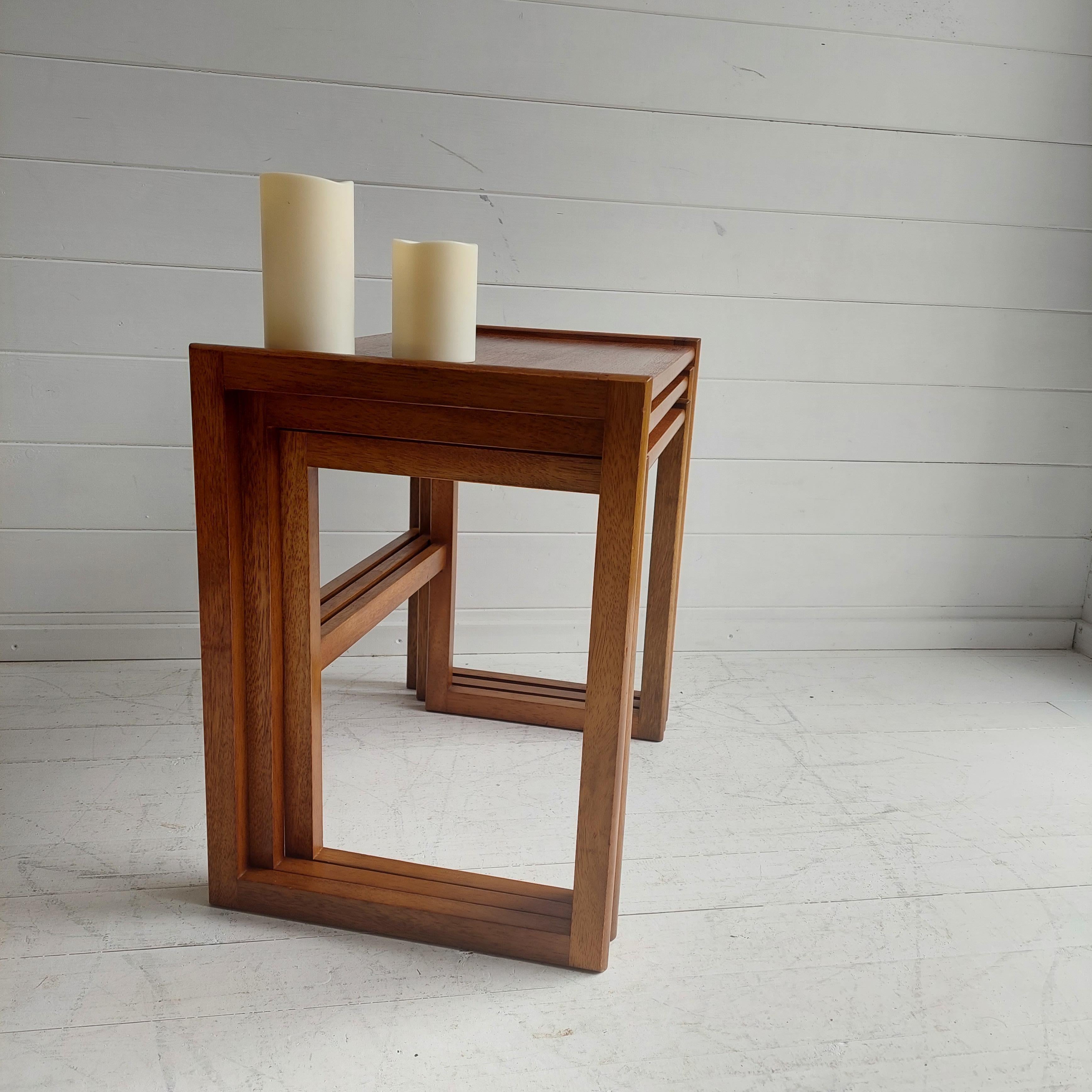 G-awesome! This beautiful set of side tables  very simliar to the G-plan design  

Executed in beautiful teak wood and special because of the wooden joints of the legs and the austere minimalistic design. 
Originates from England, 60s.
Inspired by