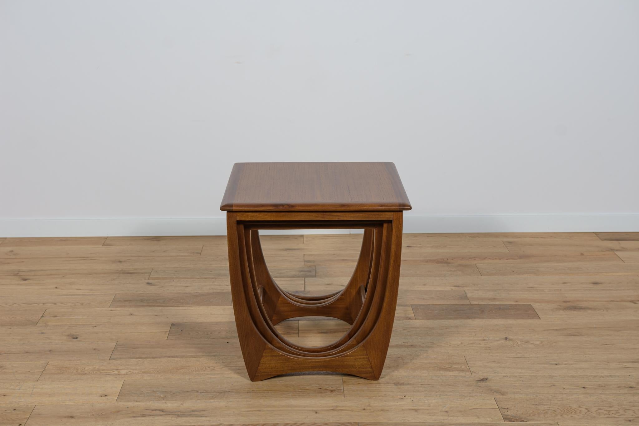 This set of three pull out tables was designed by Victor Wilkins for british manufatured G-Plan. The tables have reinforced profiled edges. Completely restored. The teak elements have been cleaned and painted oak stain and finished a strong