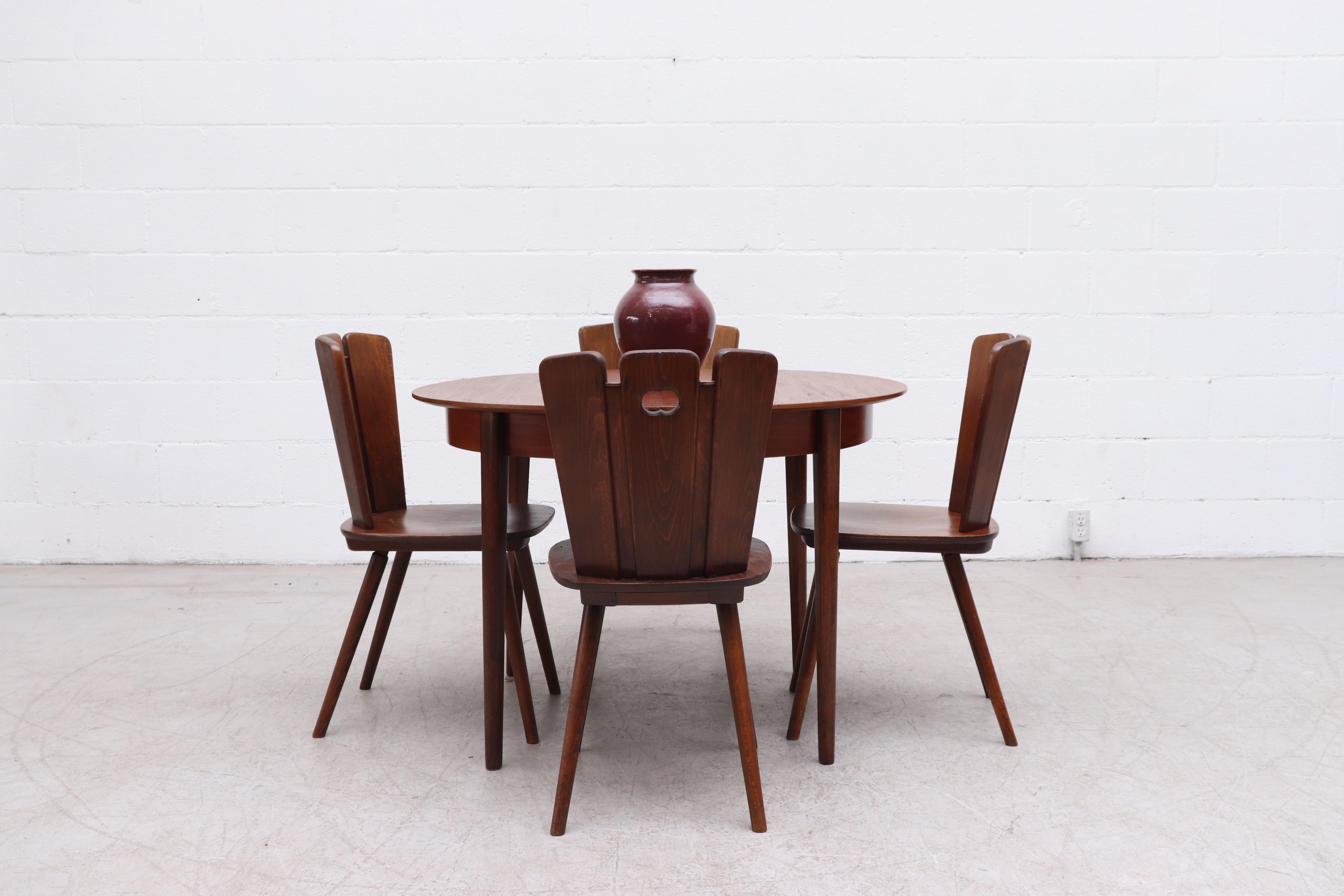 Midcentury round to oval teak dining table with hidden butterfly leaf extension and tapered teak legs. Lightly refinished in good original condition with some wear and consistent with age. Other similar tables available (LU922418396342,