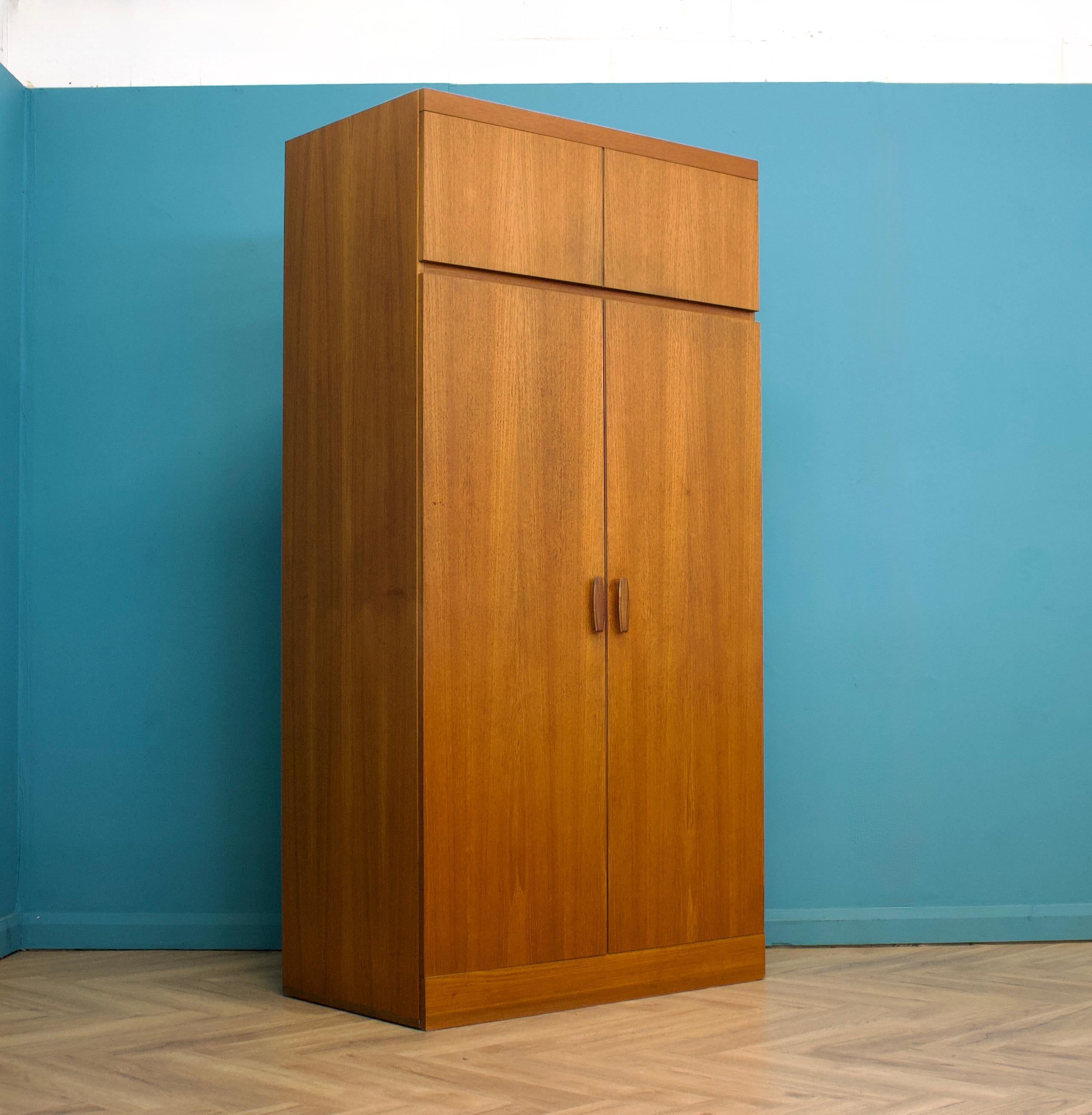 Questo armadio a tre ante freestanding della linea Quadrille di G-Plan, risalente agli anni '60 circa, è più alto del solito e realizzato in teak.


Un lato dell'armadio è dotato di un appendiabiti, mentre l'altro è rivestito di scaffali e cassetti.