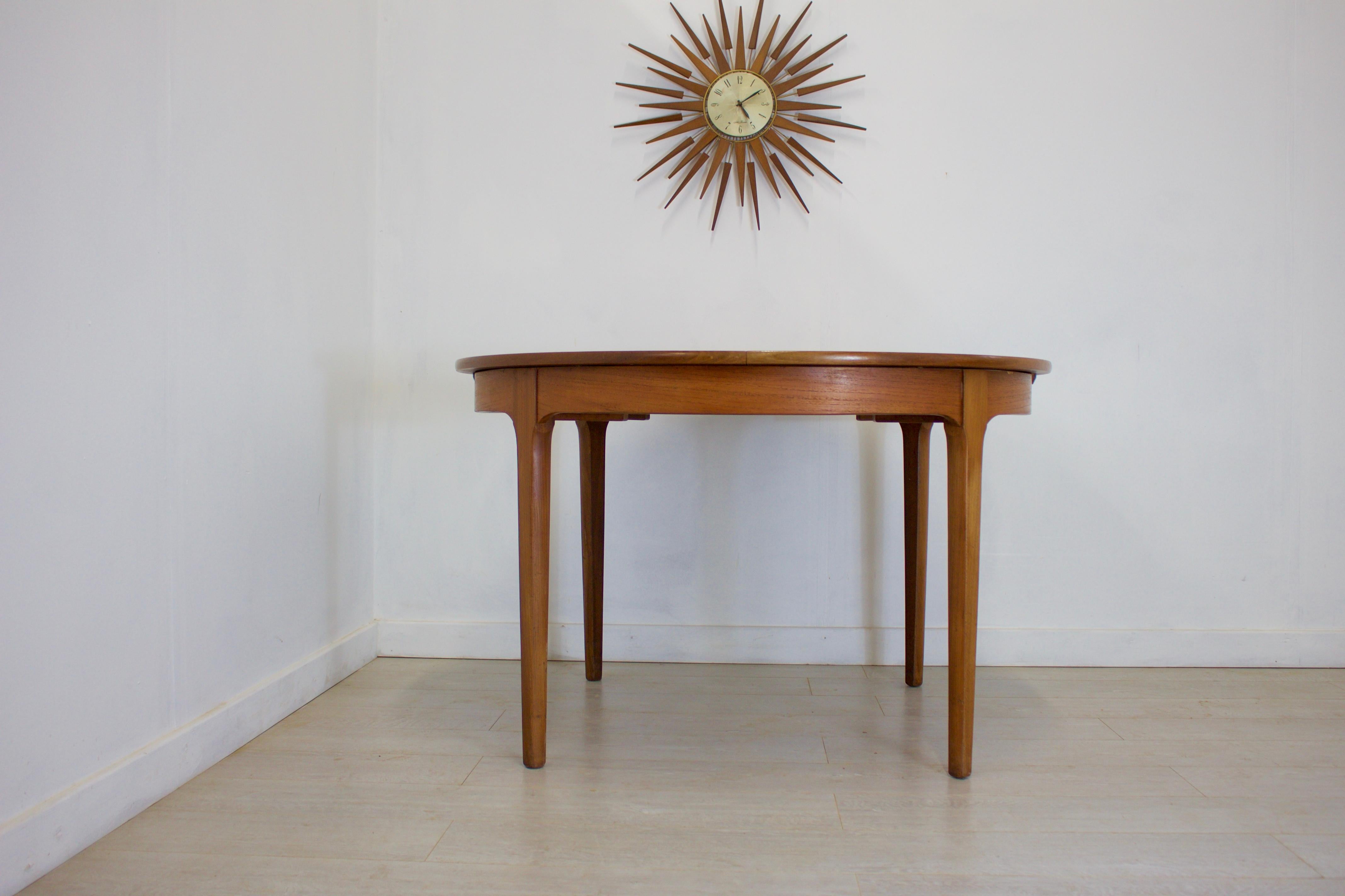 - Mid-Century Modern extending dining table
- Made in the UK by Nathan
- Made from teak and teak veneer
- Featuring 1 extending leaf
- Extended width 167 cm.