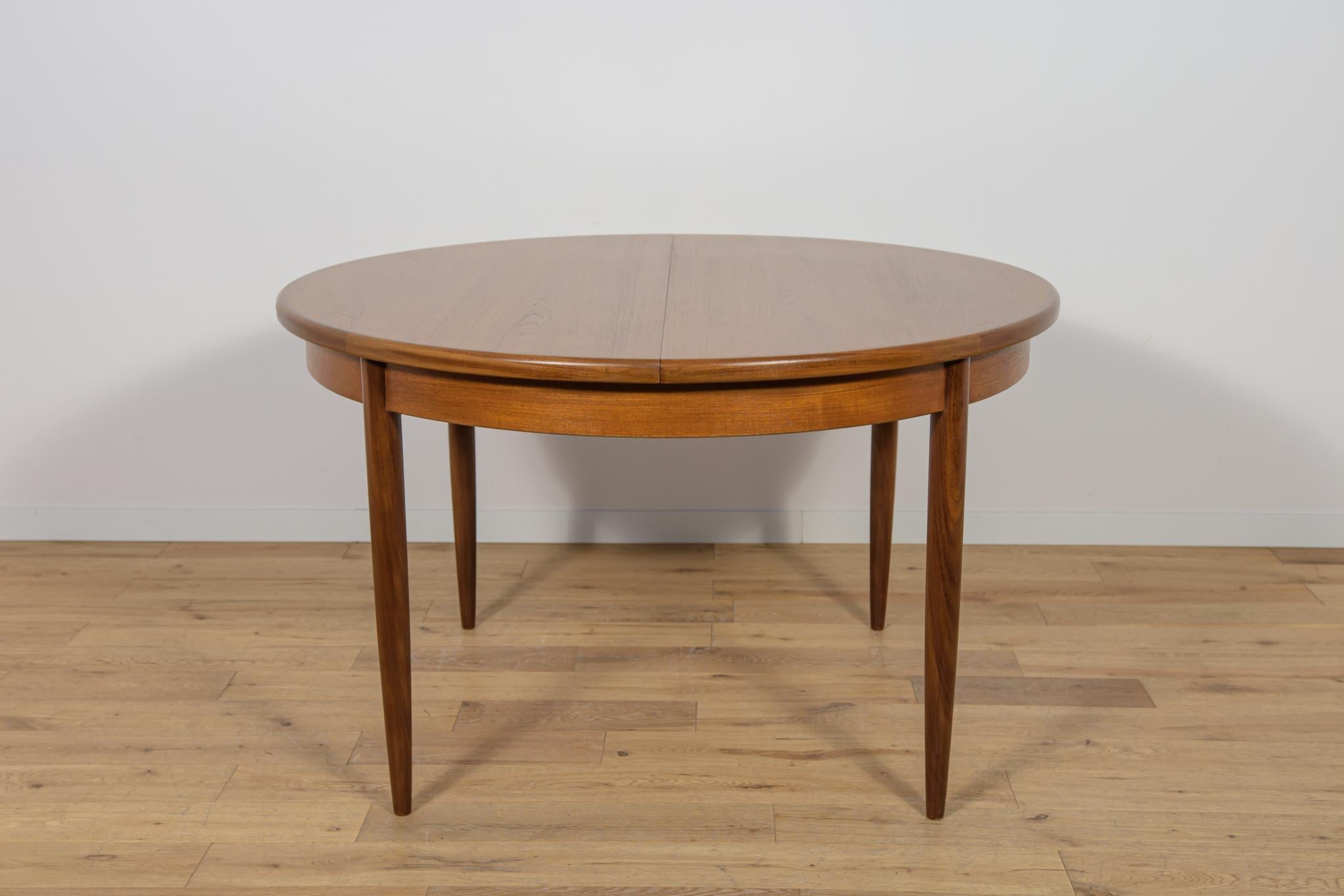 This round extendable dining table was produced by G-Plan in the 1960s. The table has profiled reinforced edges of the top. Teak elements cleaned old coating and painted oak stain and finished with strong semi matt lacquer. The table has a mechanism