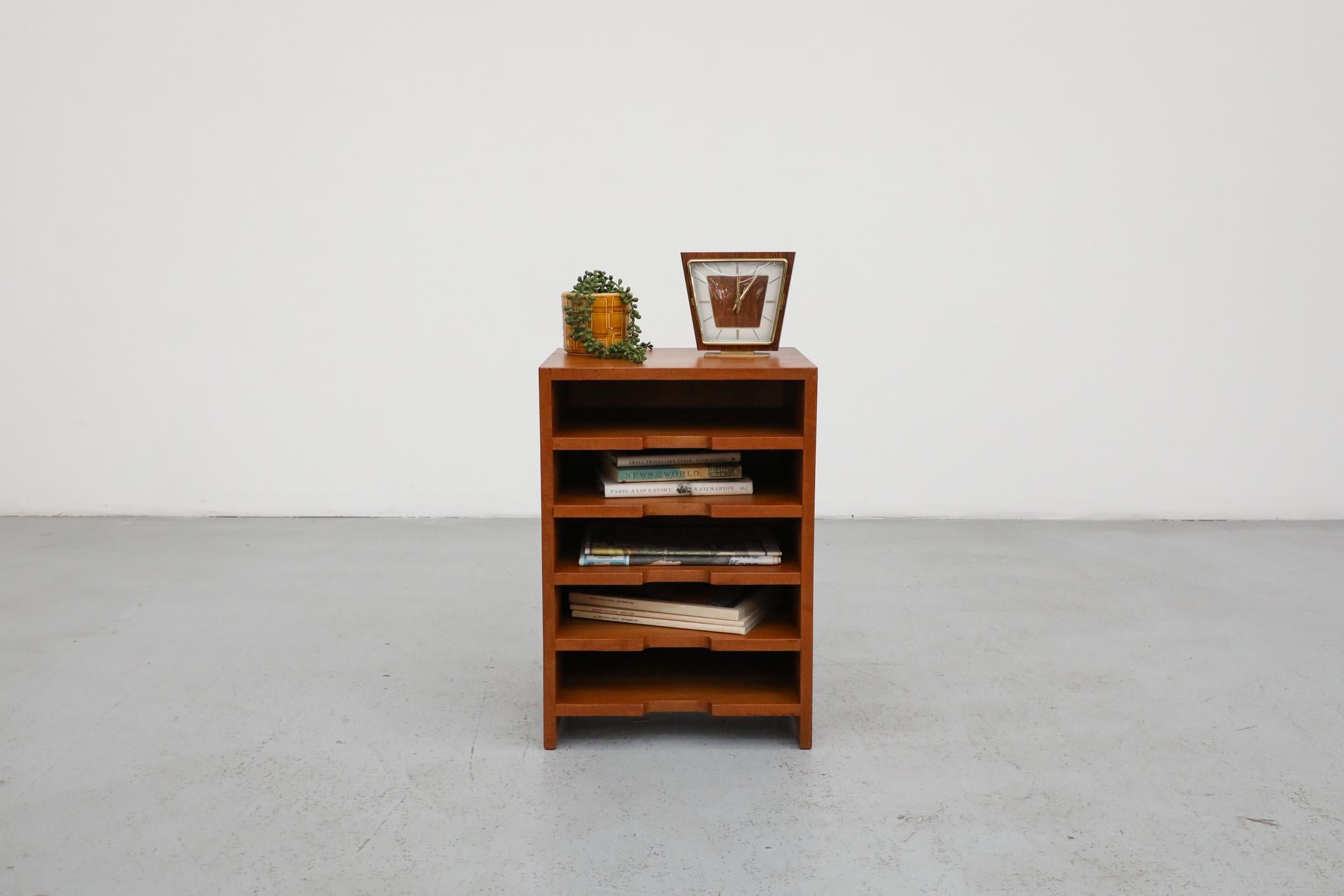 A wonderfully versatile Mid-Century teak side cabinet, aptly named ‘Desk Mate’, featuring convenient open shelves. This compact yet highly functional piece boasts a thoughtful design, making it an excellent companion for under or next to a desk in a