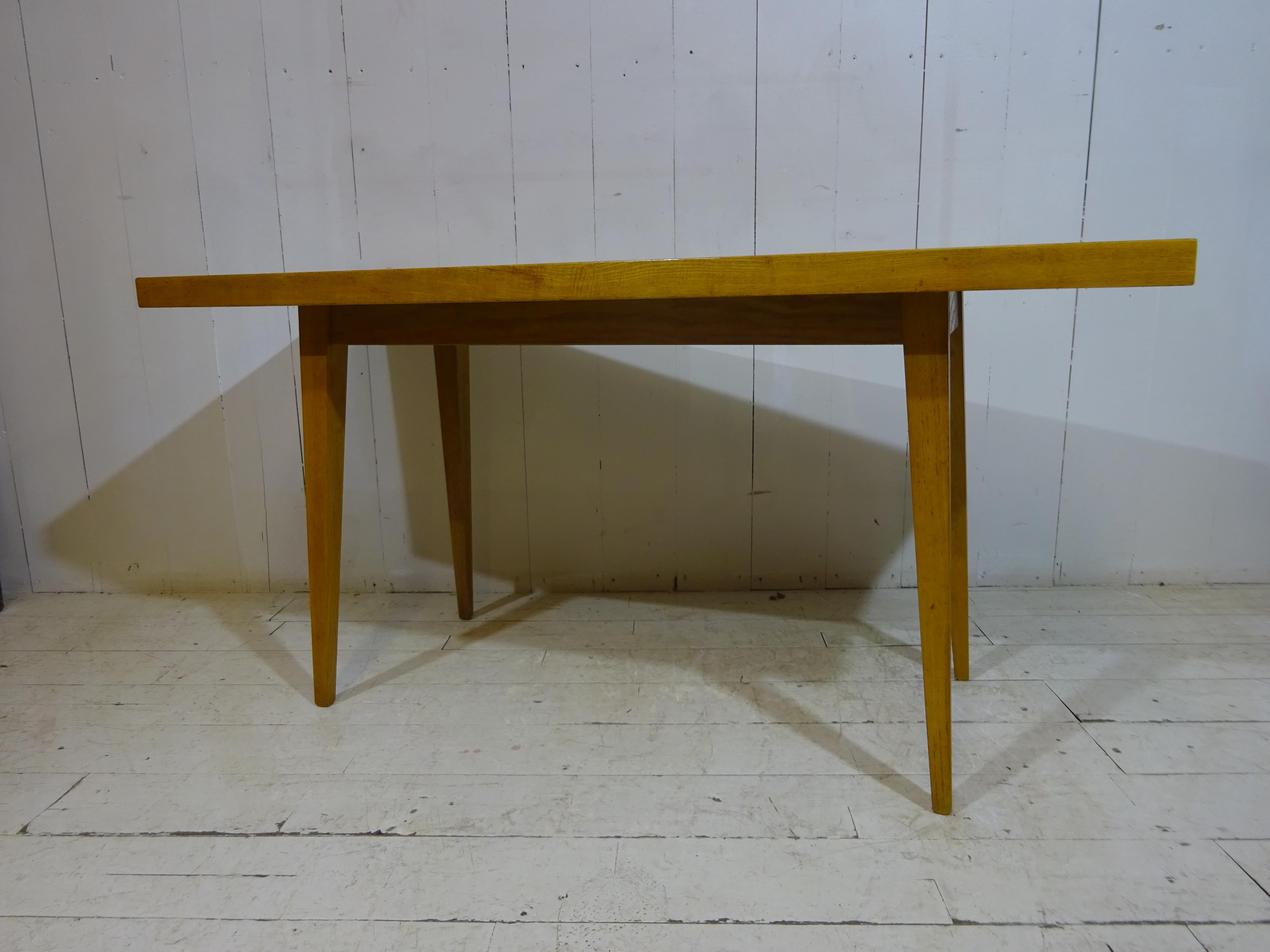 Dated Mid-1970s this is a beautiful original side or sofa table. 

Finished in a light teak and beechwood the table has a great midcentury look ideal for any room. Four square and tapered legs offer support for the table top. The top is well made