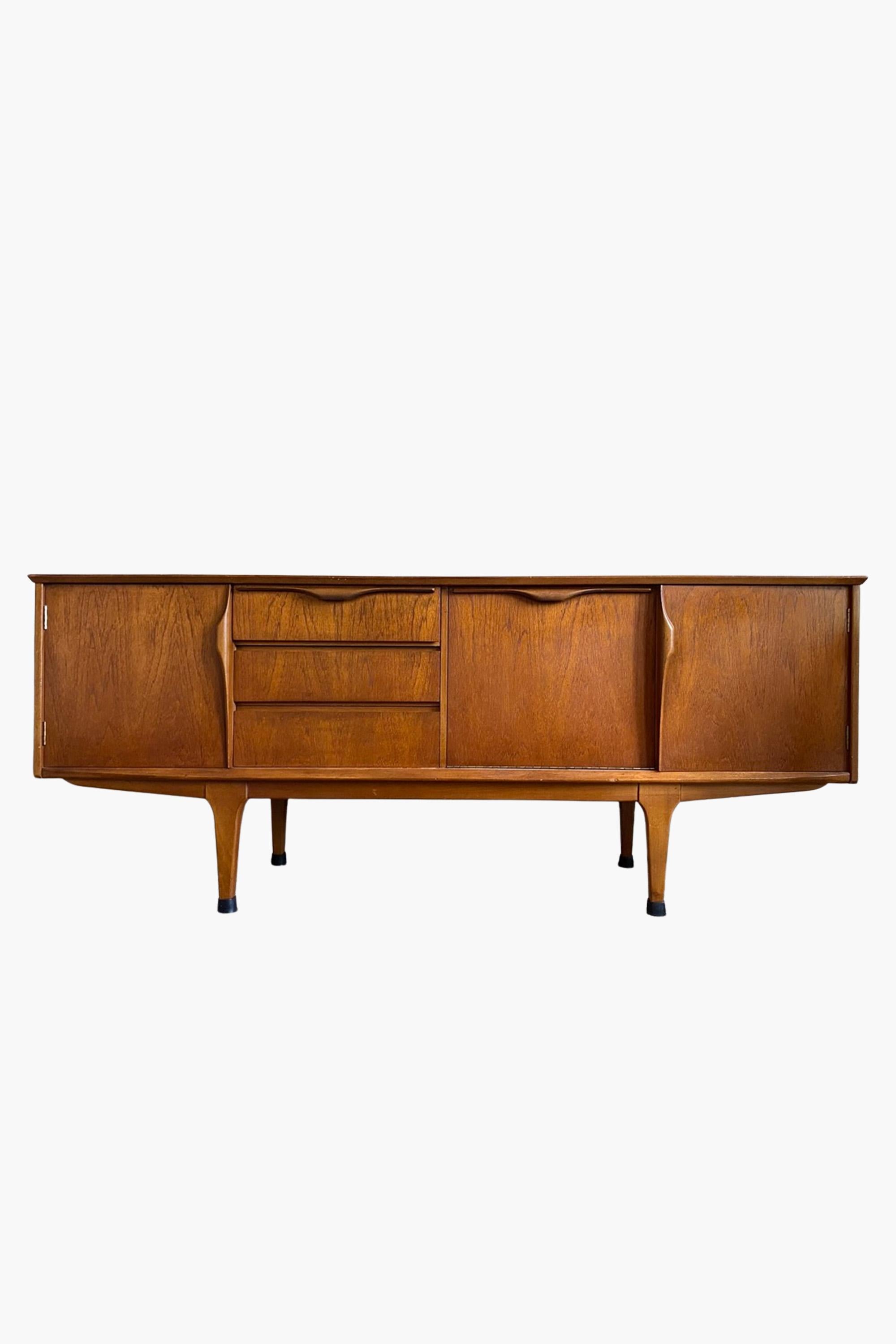 A midcentury teak sideboard by Jentique in excellent original condition.

Jentique designed and manufactured small batches of high quality Danish-inspired furniture in Norfolk in the 1950s and 60s. Their designs were retailed by iconic London